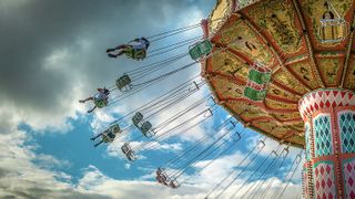 Riders swing on a giant amusement park swing ride.