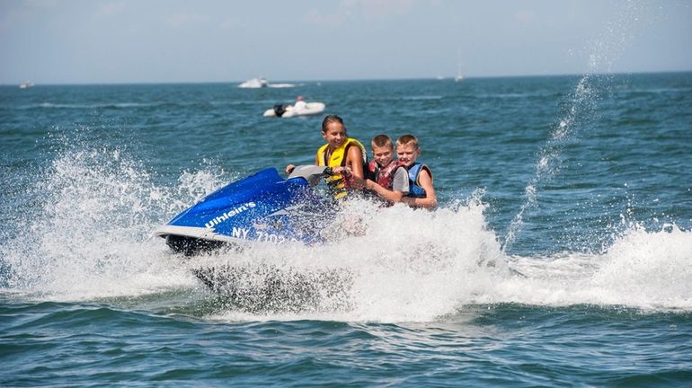 Jordan Steele steers as Gabriel Robert, 10, and Nicholas Robert,...