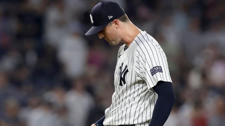 Clay Holmes of the New York Yankees reacts after surrendering...