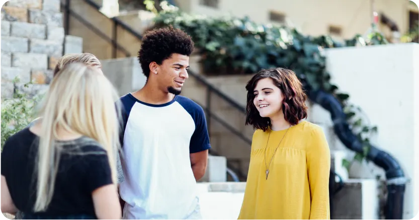 Group of teens standing outside in a circle