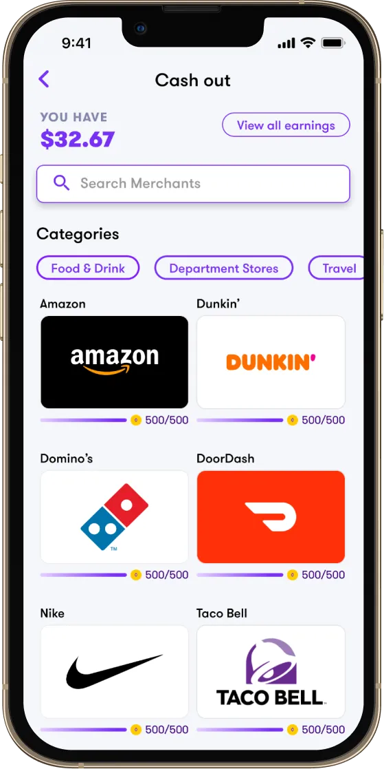 A phone showing the Cash out screen & gift card selections for Amazon, Domino’s, and Dunkin Donuts, with floating Roblox, PlayStation, and XBOX gift cards beside it.
