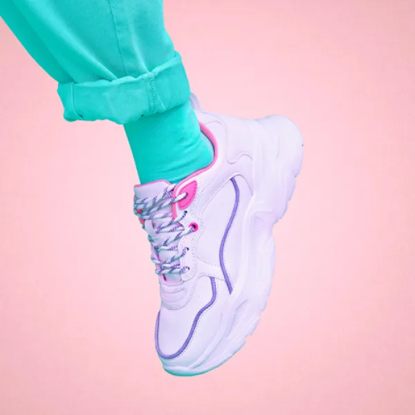 white sneaker in a pink background