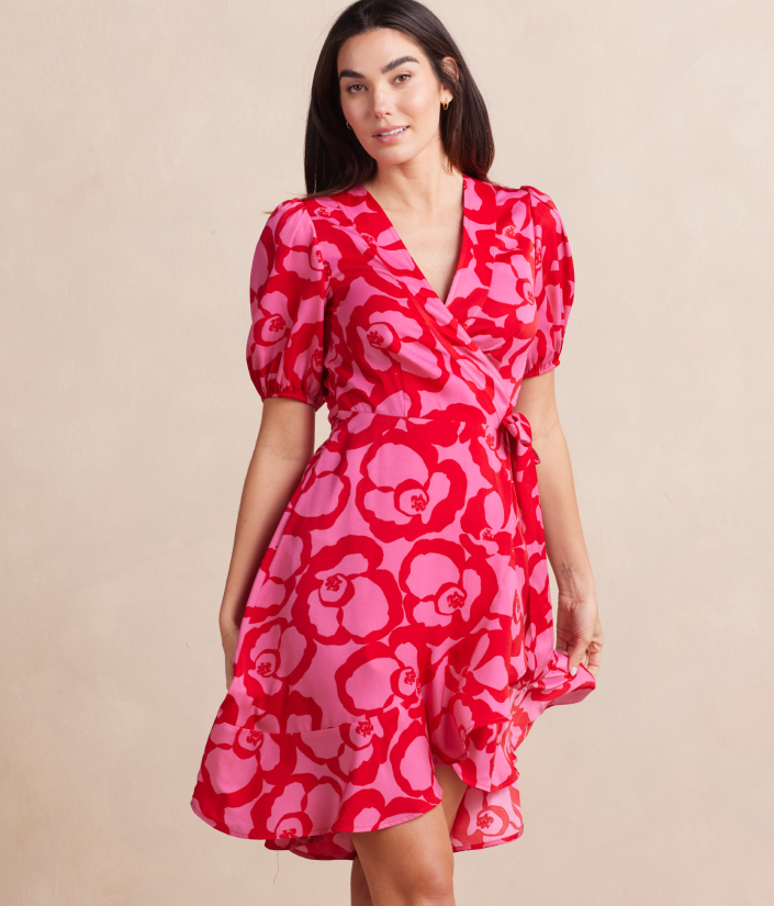 Model in dress, The Silky Luxe Puff Sleeve Beach to Brunch Wrap Dress - Pop Floral in Lava (Pink and red floral print)