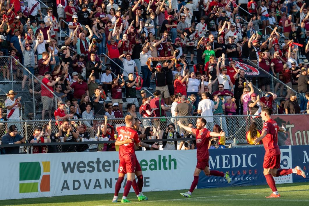 Phillips celebrates with his Republic teammates against the Quakes