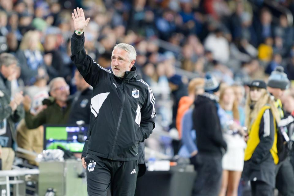 Sean McAuley waves to the crowd in Minnesota United gear