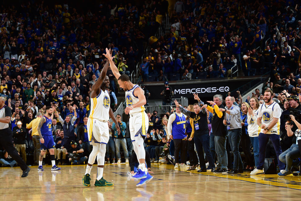 SAN FRANCISCO, CA - APRIL 18: Stephen Curry #30 of the Golden State Warriors high fives Draymond Green #23 of the Golden State Warriors during Round 1 Game 2 of the 2022 NBA Playoffs on April 18, 2022 at Chase Center in San Francisco, California. NOTE TO USER: User expressly acknowledges and agrees that, by downloading and or using this photograph, user is consenting to the terms and conditions of Getty Images License Agreement. Mandatory Copyright Notice: Copyright 2022 NBAE (Photo by Noah Graham/NBAE via Getty Images)