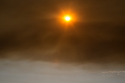 Dark afternoon smoke from the Alamo Fire burning in the nearby coastal mountains, within view of the Pacific Ocean, creates an eerie, surreal scene on July 9, 2017, near Santa Maria, California.