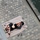 A woman sunbathes next to the Seine river in Paris, France.