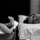 A mother looks at her newborn baby's feet