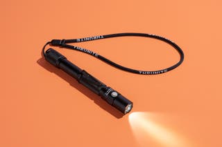 A slim metal flashlight about six inches long