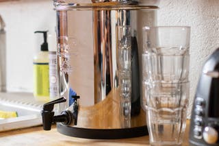 A closeup of the Big Berkey on a counter by a sink.