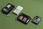 All of our picks for best rechargeable battery charger, shown in a row with some batteries in and out of the chargers.