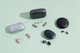 An array of over-the-counter hearing aids, together with their cases, that we tested to find the best hearing solutions.