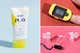 A bottle of Supergoop! sunscreen, a pulse oximeter on a finger and a portable breast pump