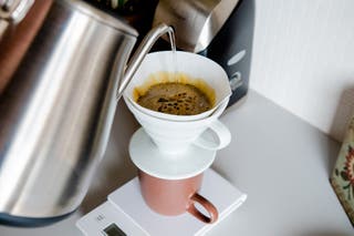 Someone pouring coffee into a pour-over coffee maker.