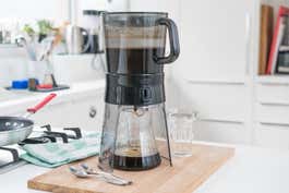 Our pick for best cold-brew coffee maker sitting on a wood cutting board on top of a kitchen counter.