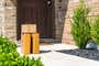 Packages stacked on a walkway leading to a residential front door