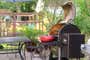 A enameled cast iron pan sitting on an open outdoor grill.