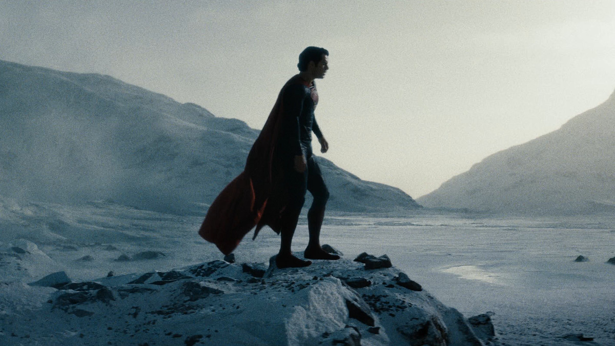 Henry Cavill’s Superman stands in costume on a snowy rock, with nothing but desolate ice around him.
