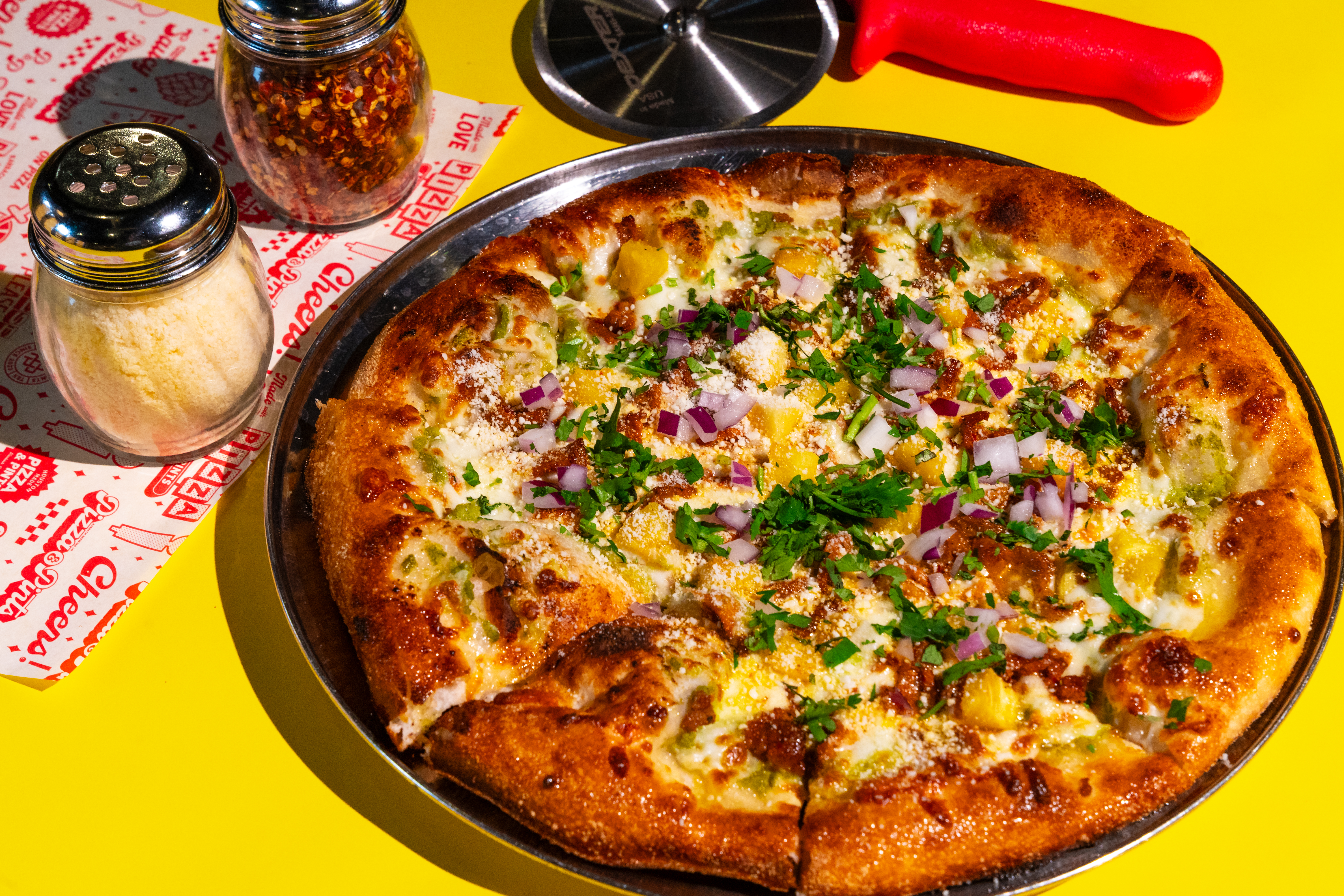 Pizza &amp; Pints’s al pastor pizza features pineapple, pork, salsa verde, cilantro, and cotija cheese.