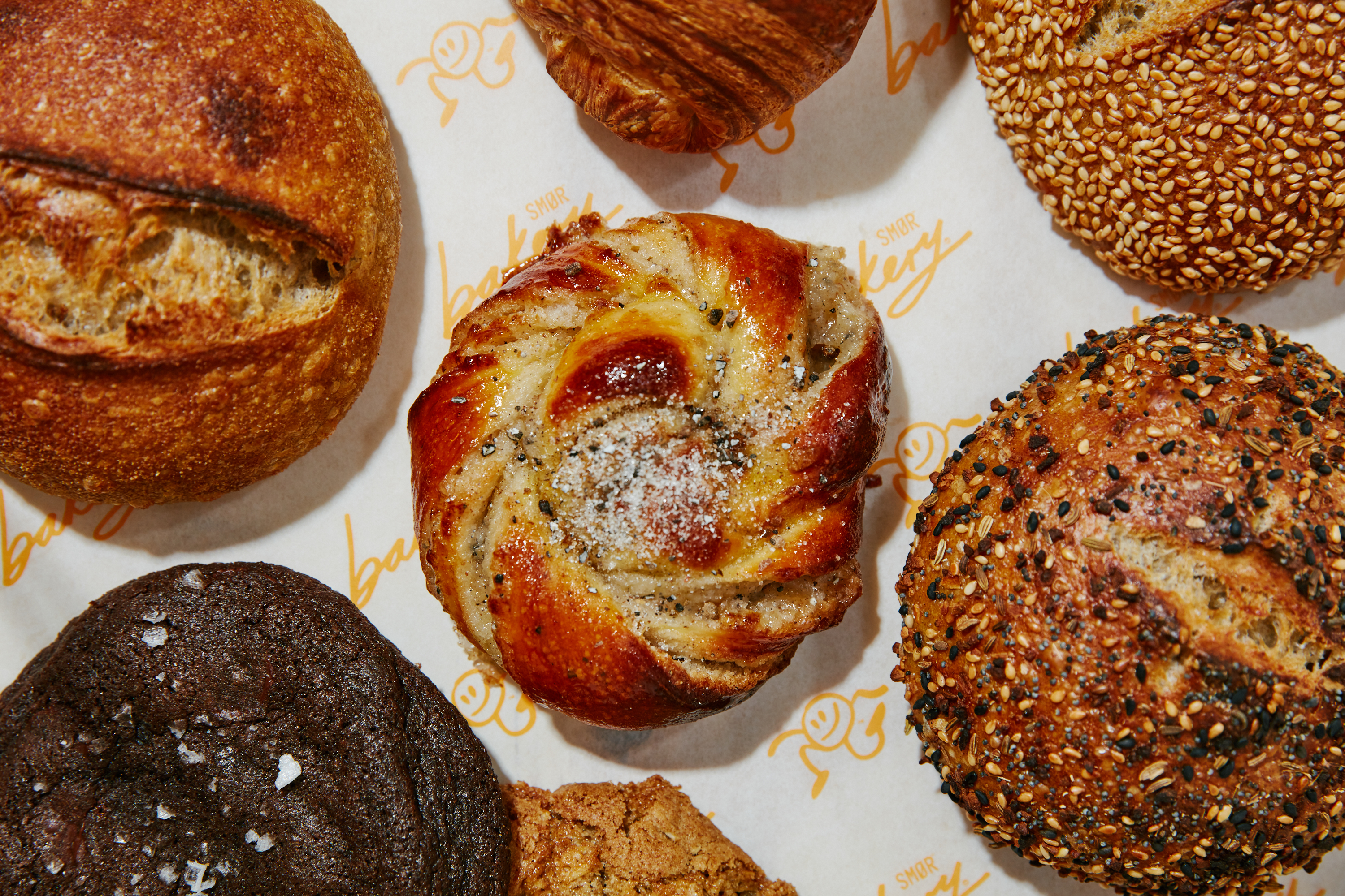 A selection of pastries are photographed on white paper.