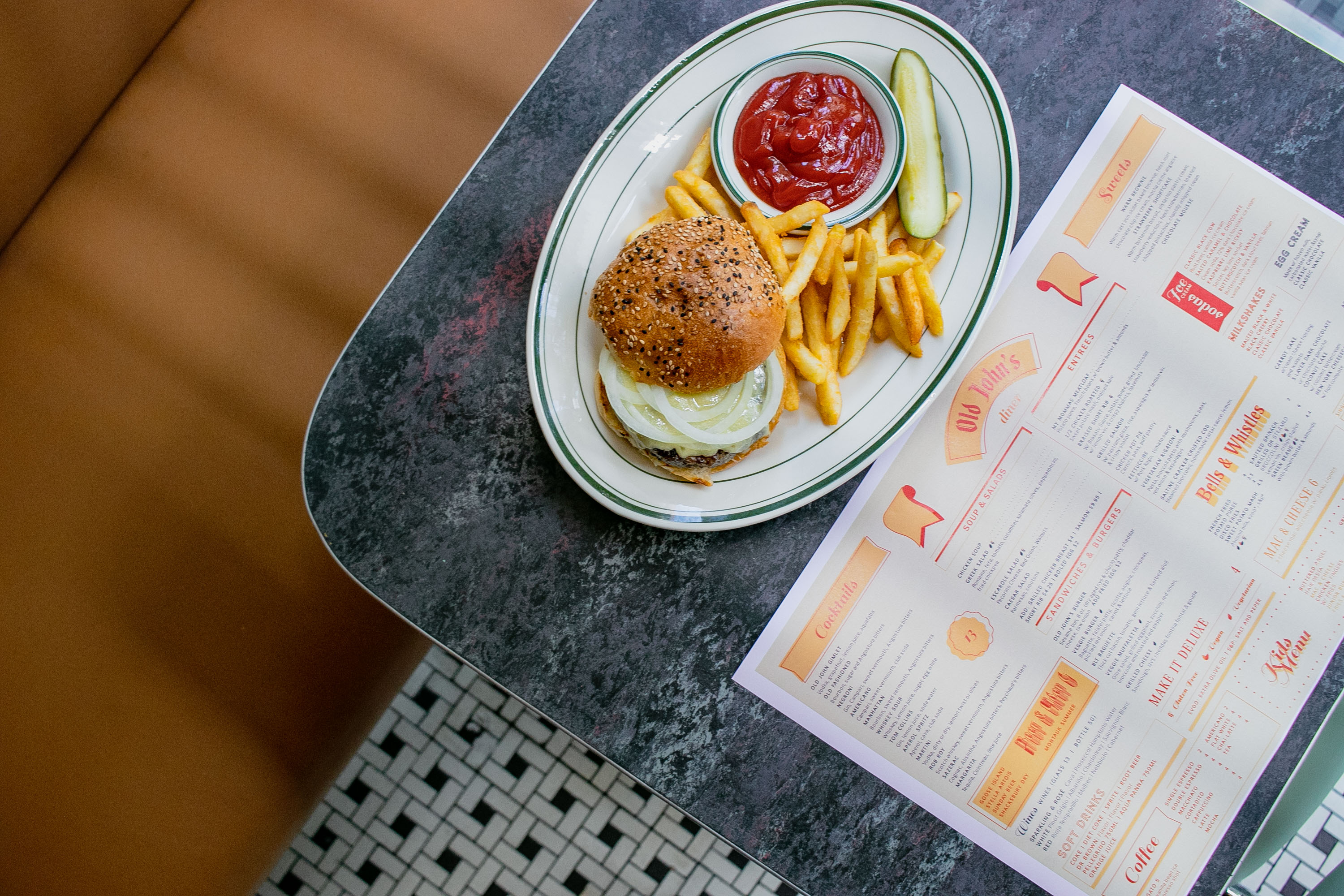 A burger and fries on a diner table. 