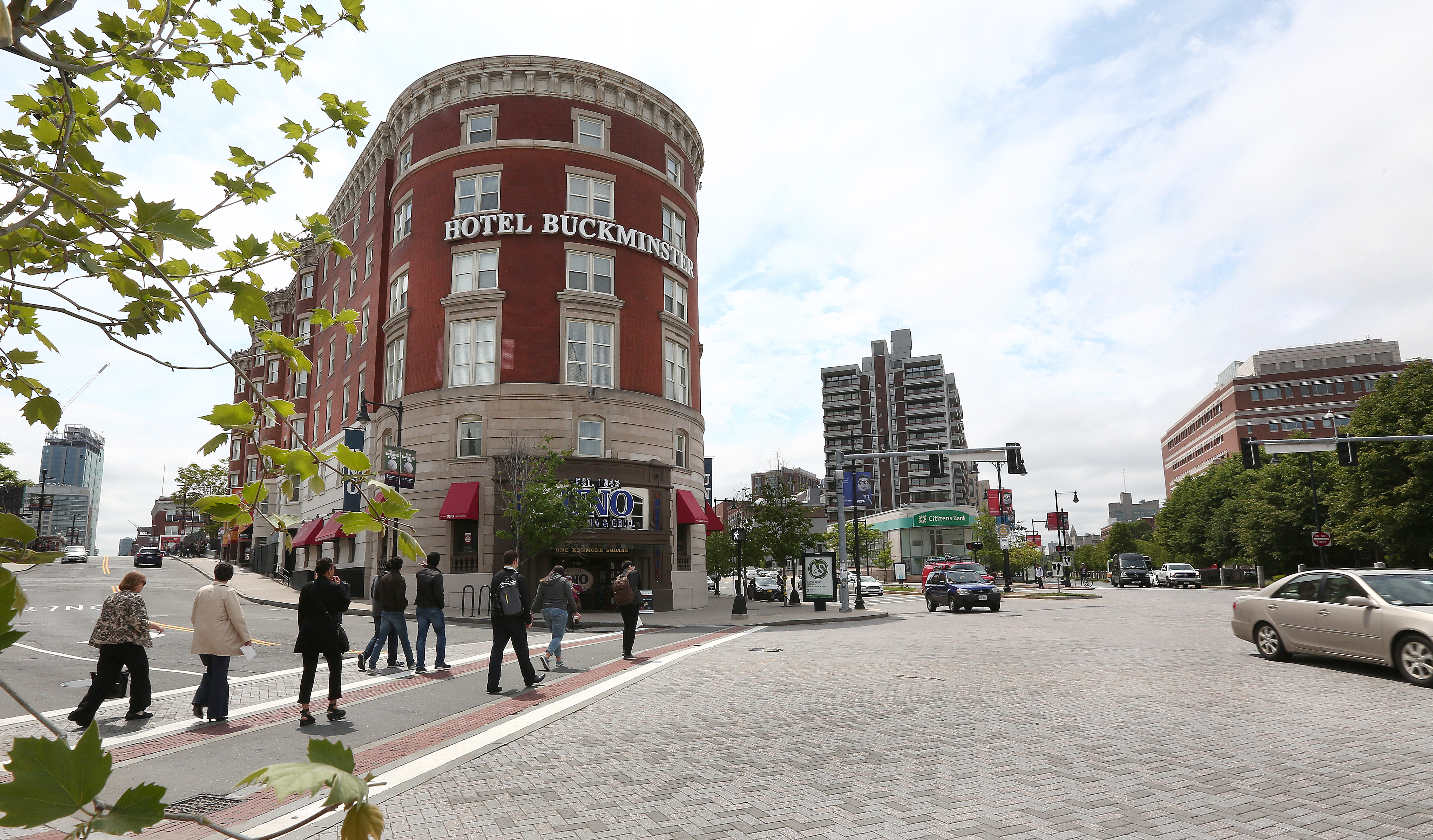 A hotel with an oval shape jutting into a busy streetscape.