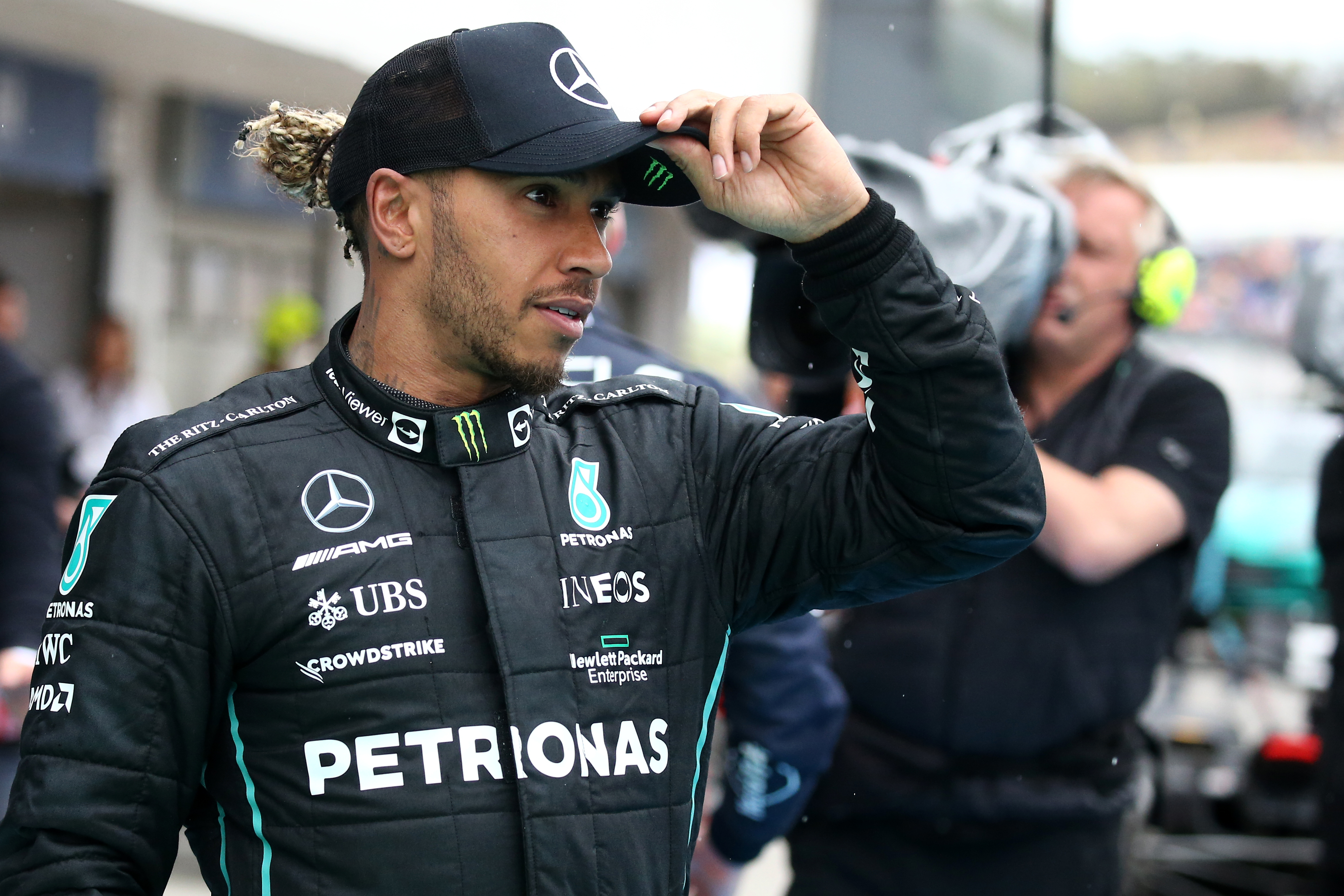 Lewis Hamilton of Mercedes AMG Petronas F1 Team looks on at...