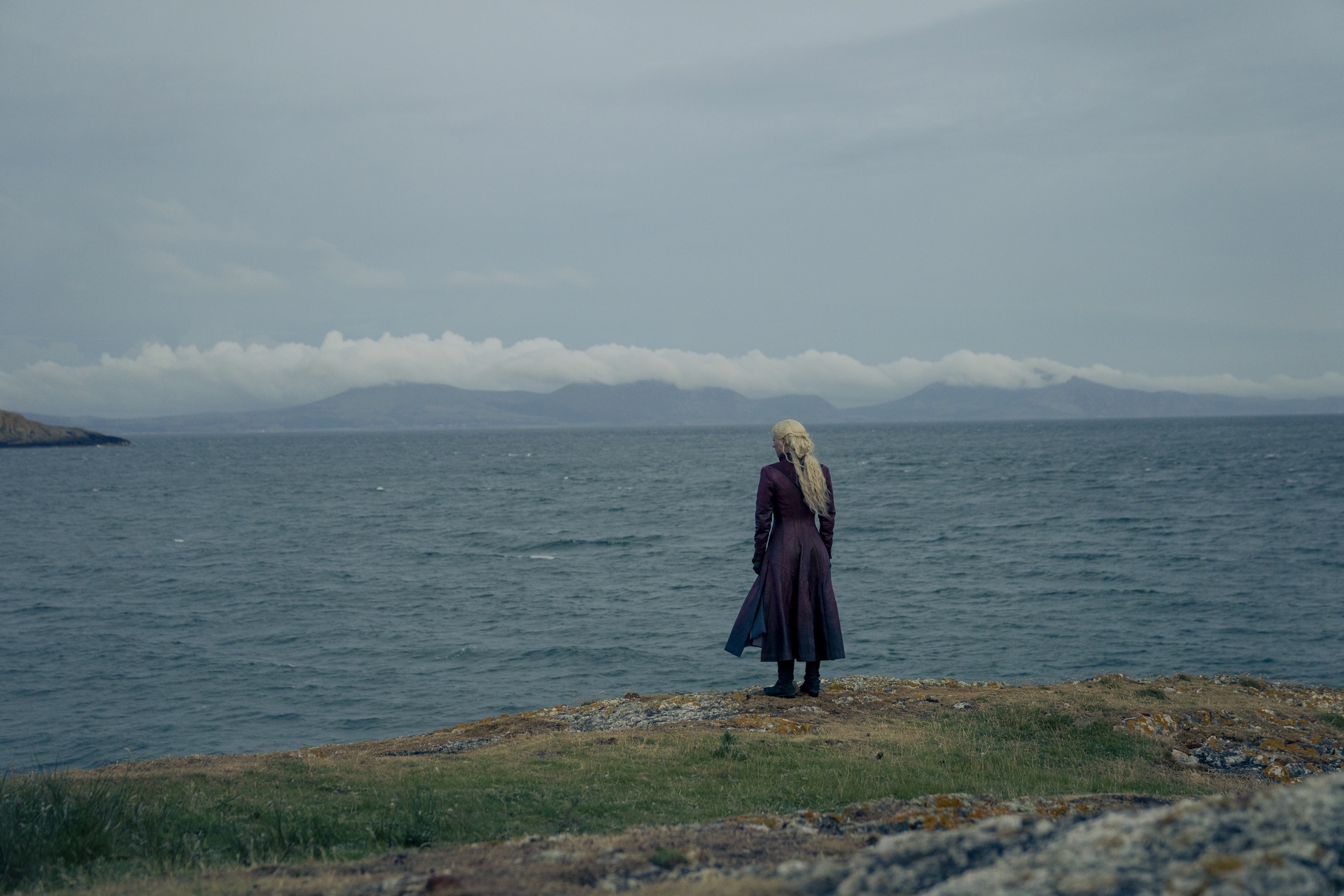 Rhaenyra standing on a cliff in a still from House of the Dragon season 2 episode 1