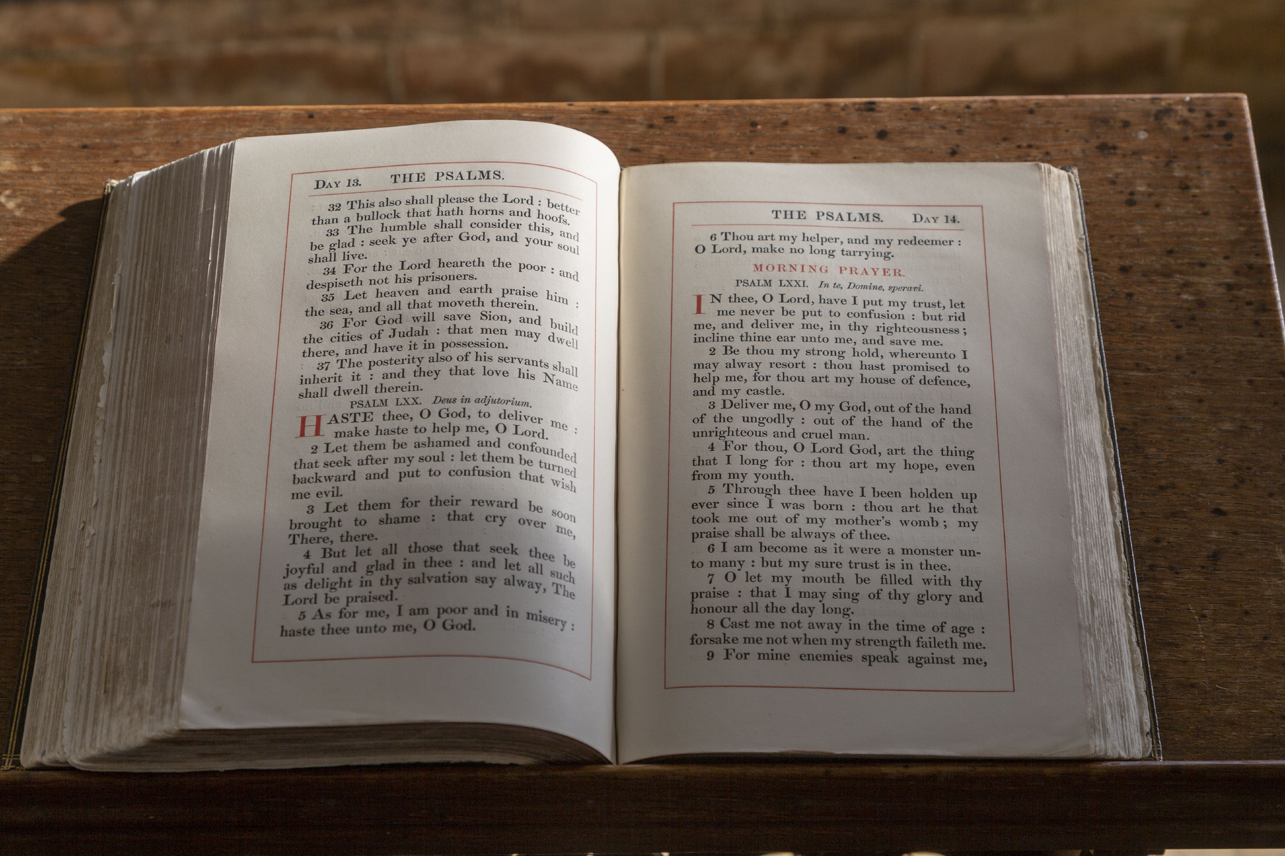 Old bible book open on page of The Psalms close-up in church at Wissett, Suffolk, England, UK