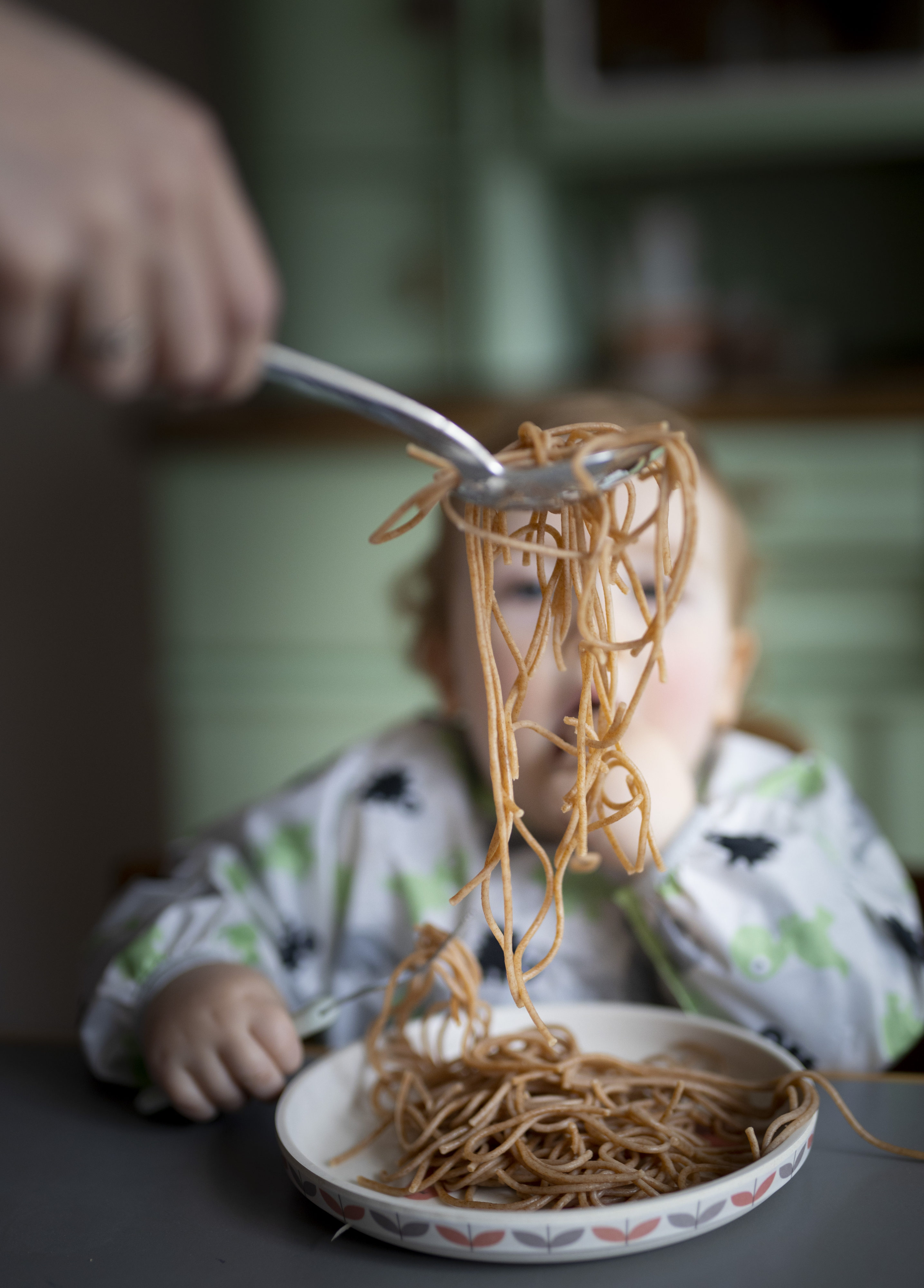 Toddler eating noodles