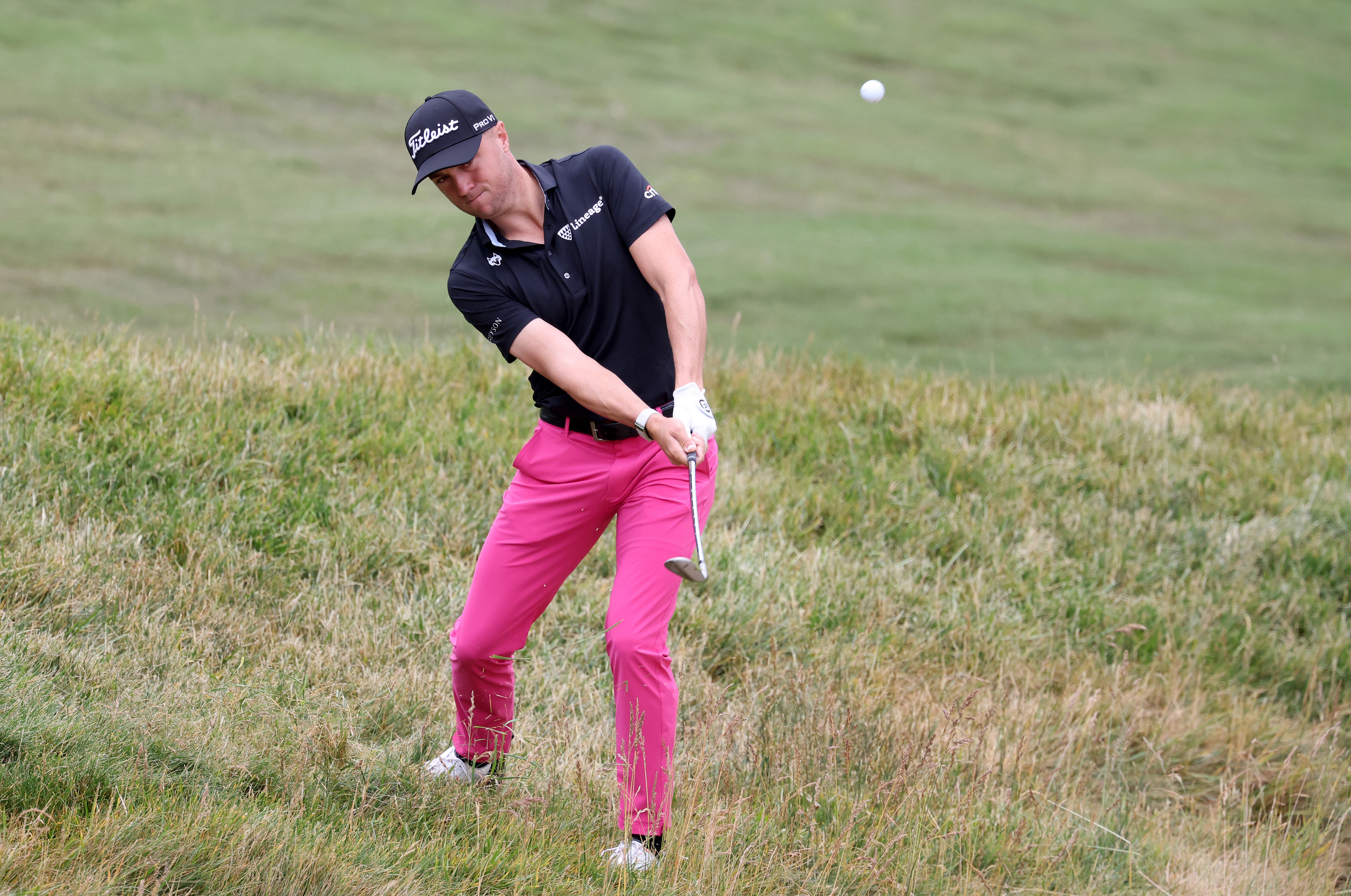 Justin Thomas plays a shot from the rough on the 7th hole during the first round of the U.S. Open golf tournament at Los Angeles Country Club.