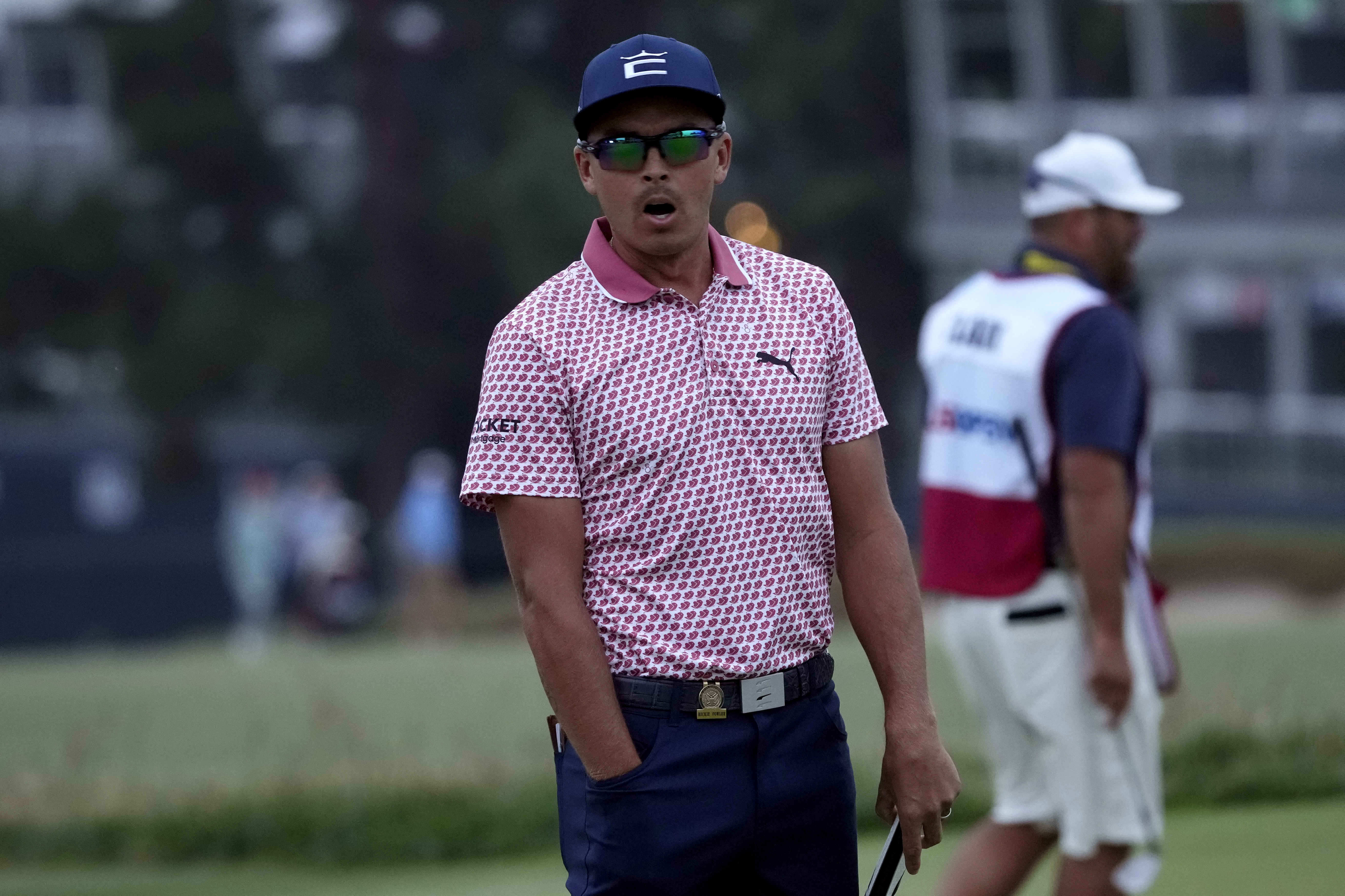 Rickie Fowler reacts after putting on the eighteenth hole during the third round of the U.S. Open golf tournament at Los Angeles Country Club.