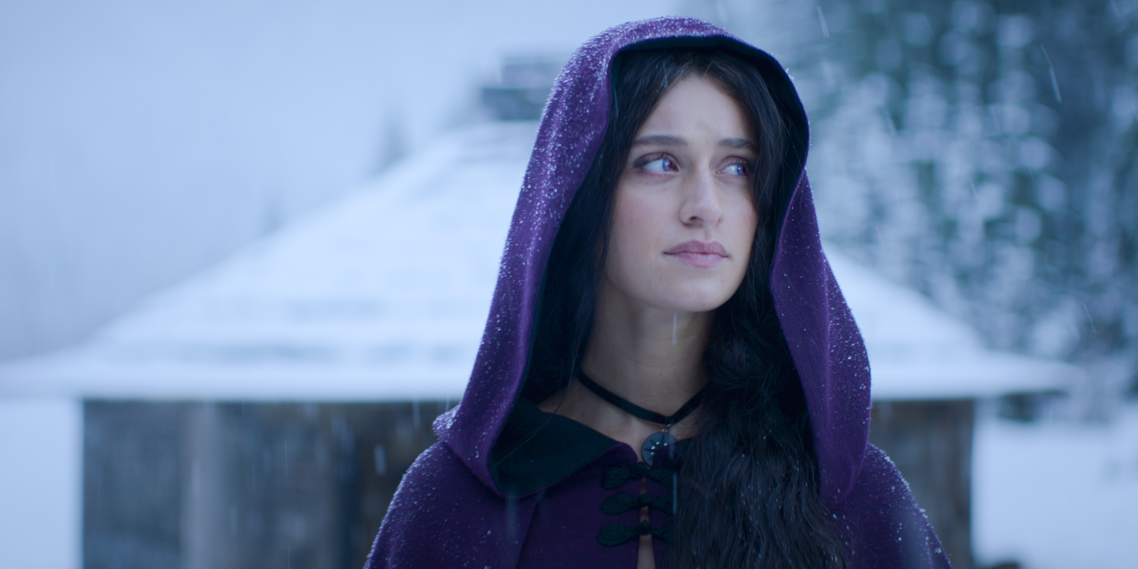 Yennefer (Anya Charlotra) looking sad in the snow in Netflix’s The Witcher.