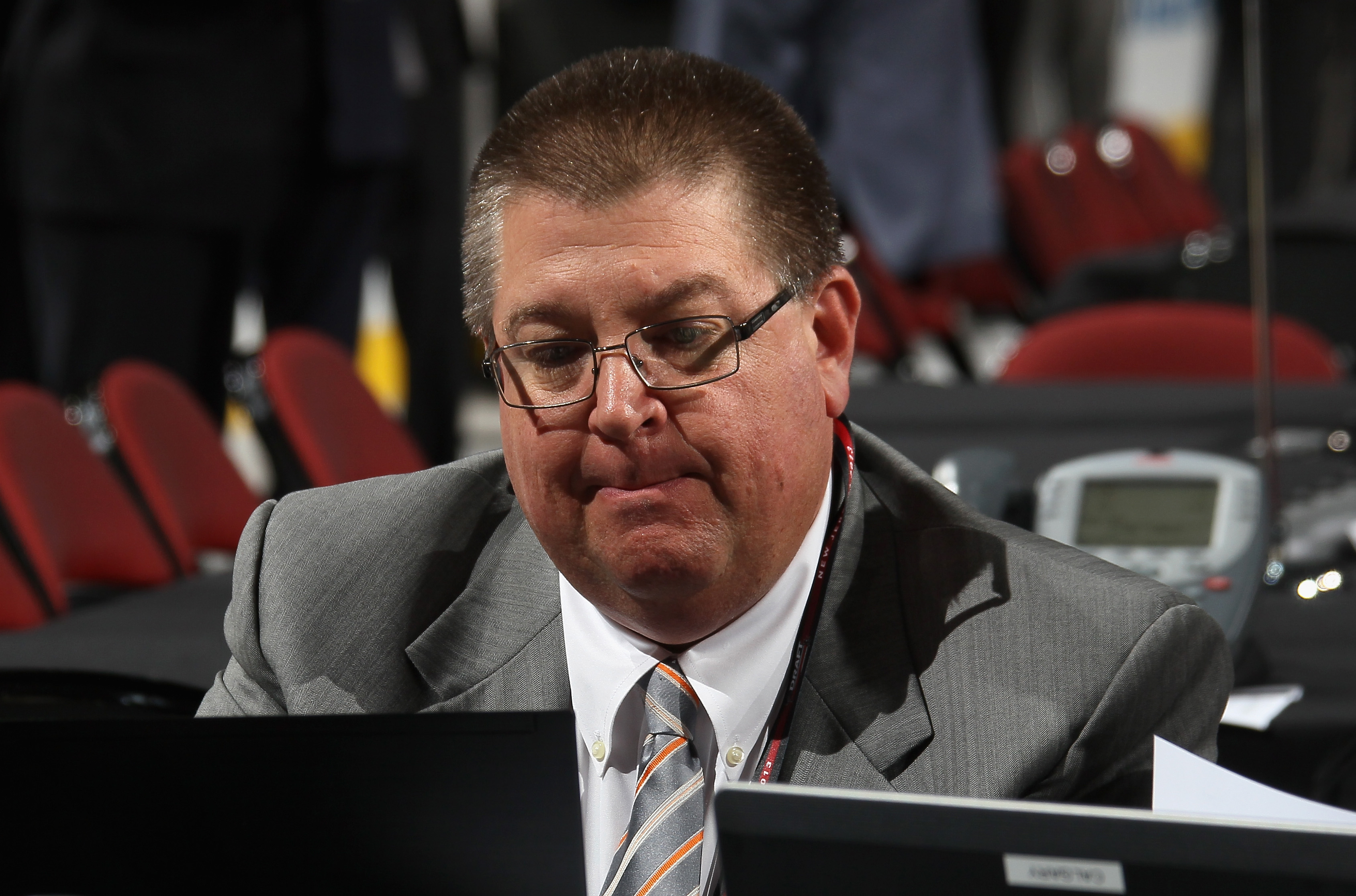 General Manager Jay Feaster of the Calgary Flames sits at his computer on the draft floor during the 2013 NHL Draft at the Prudential Center on June 30, 2013 in Newark, New Jersey.