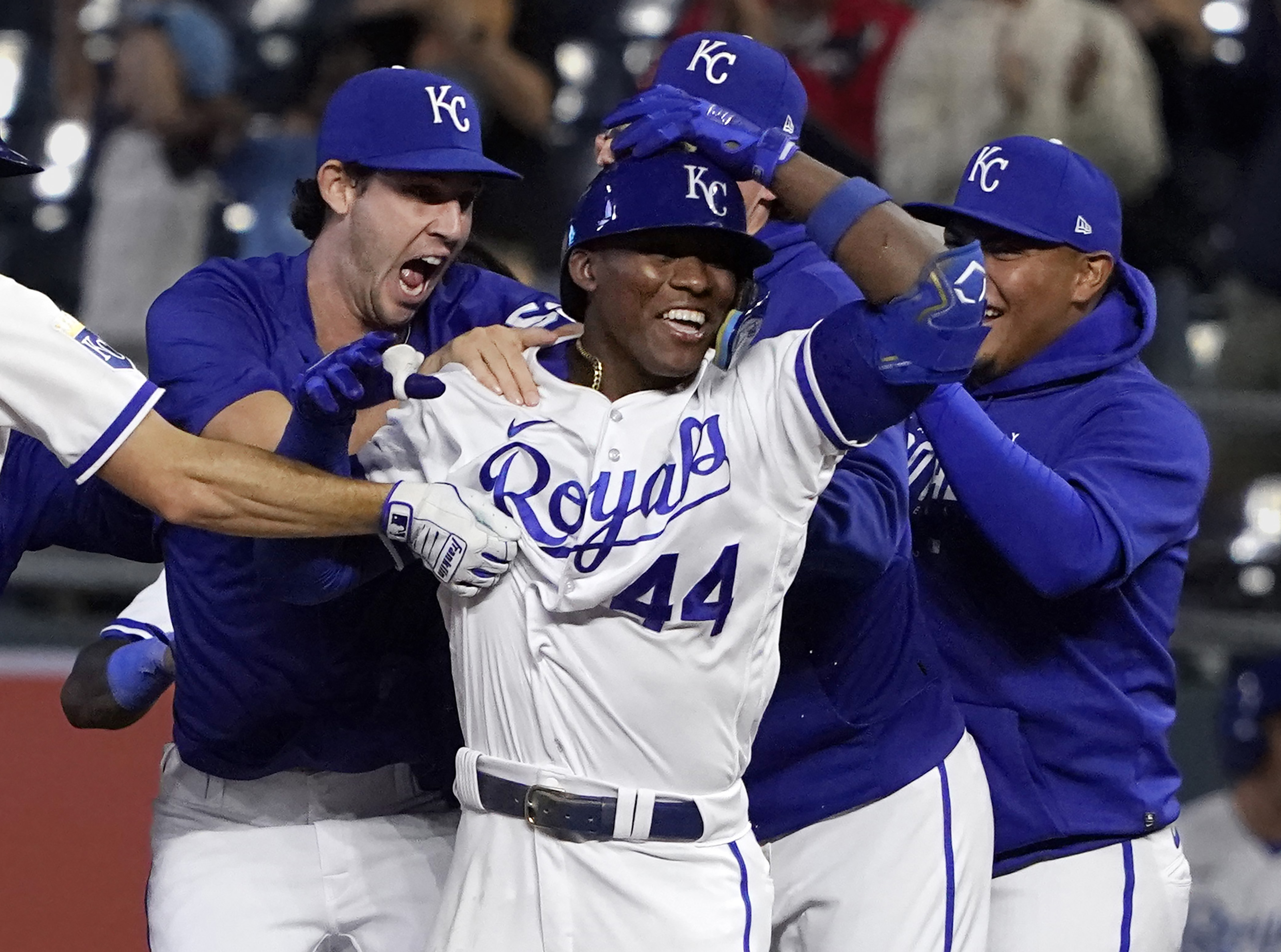 Dairon Blanco #44 of the Kansas City Royals celebrates with teammates after his walk-off bunt in the ninth inning against the Seattle Mariners at Kauffman Stadium on August 14, 2023 in Kansas City, Missouri. The Royals won 7-6.