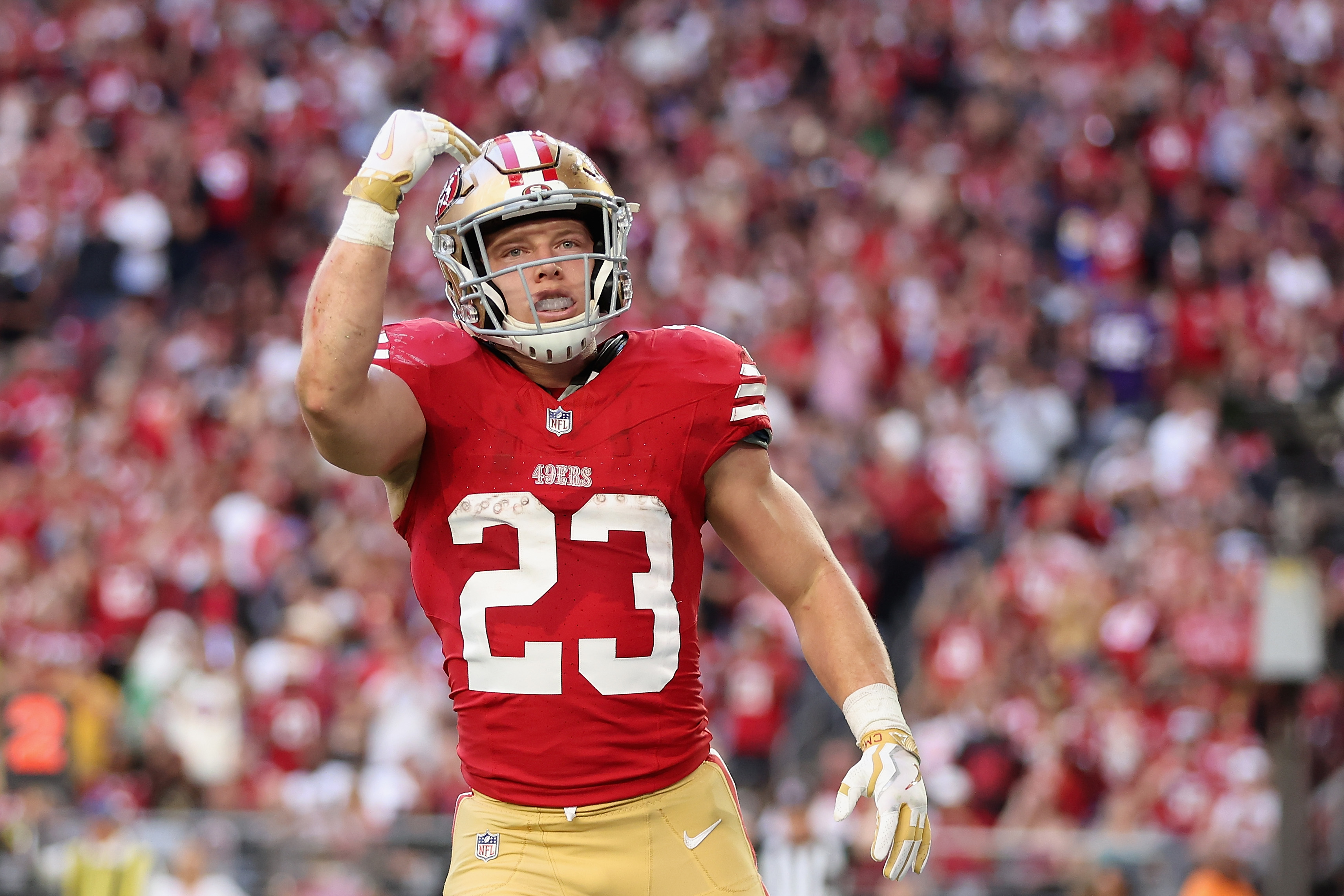 Running back Christian McCaffrey #23 of the San Francisco 49ers celebrates after scoring a 5-yard rushing touchdown against the Arizona Cardinals during the second quarter of the NFL game at State Farm Stadium on December 17, 2023 in Glendale, Arizona. The 49ers defeated the Cardinals 45-29.