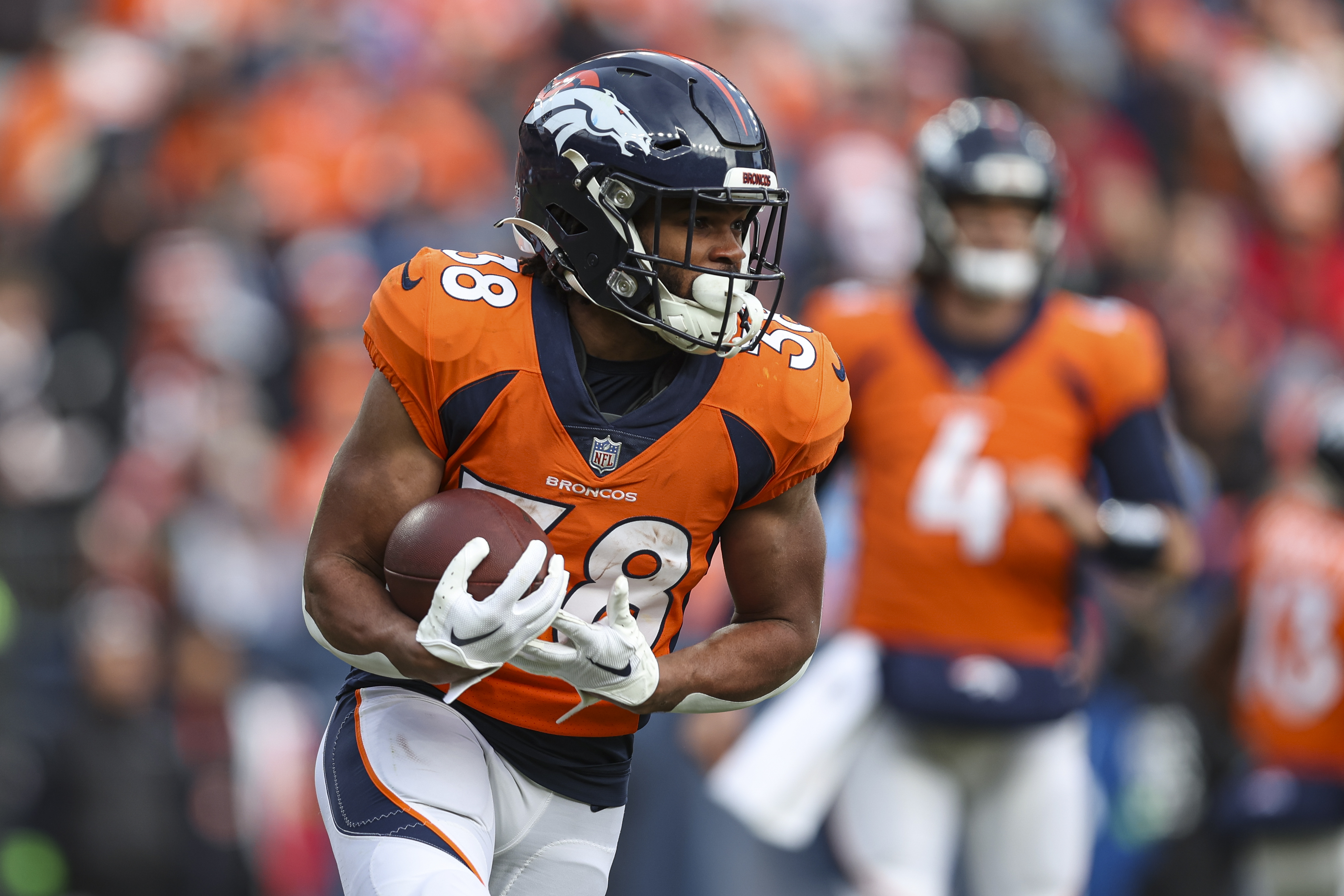 Jaleel McLaughlin #38 of the Denver Broncos runs the ball during an NFL football game against the Los Angeles Chargers at Empower Field at Mile High on December 31, 2023 in Denver, Colorado.