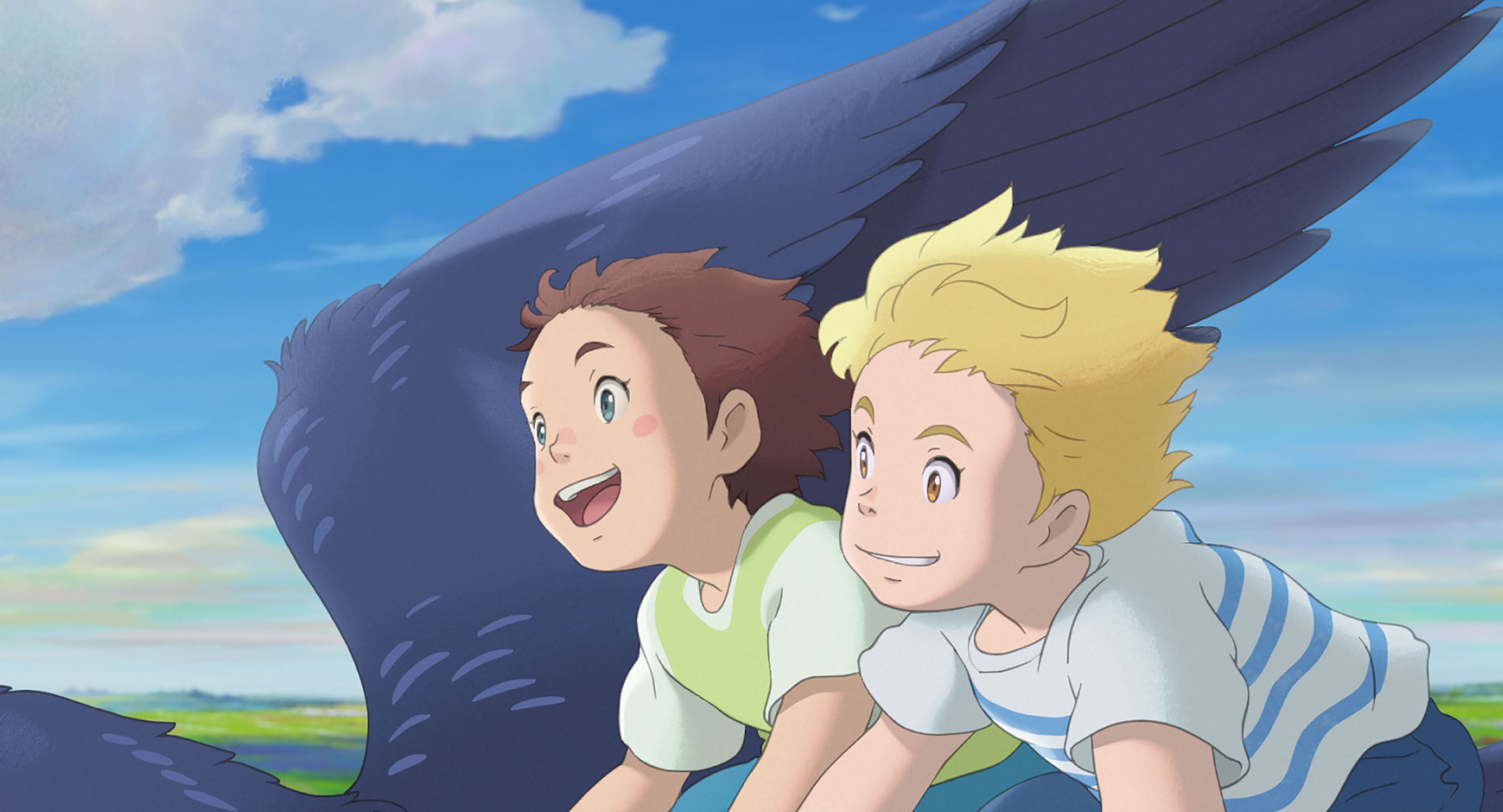 Amanda, a young brown-haired girl, and her imaginary friend Rudger, a similarly aged blond boy, both grin as they fly through the sky on a giant bird in a scene from Studio Ponoc’s anime movie The Imaginary 