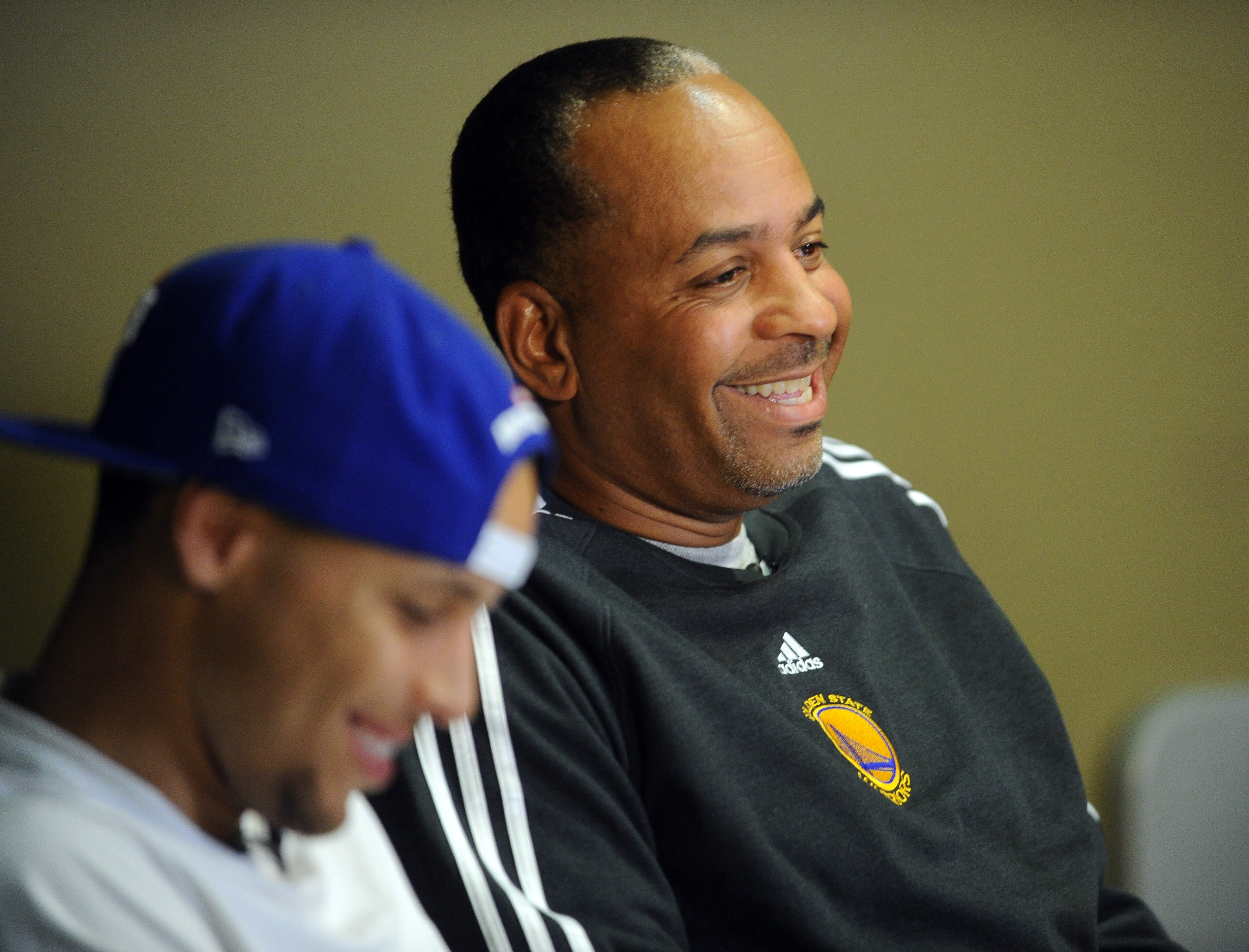 Golden State Warriors player Stephen Curry, left, listens to his father Dell Curry, a former National Basketball Association player, as he talks about having a son playing in the NBA during an interview in the Golden State Warriors training facility playe