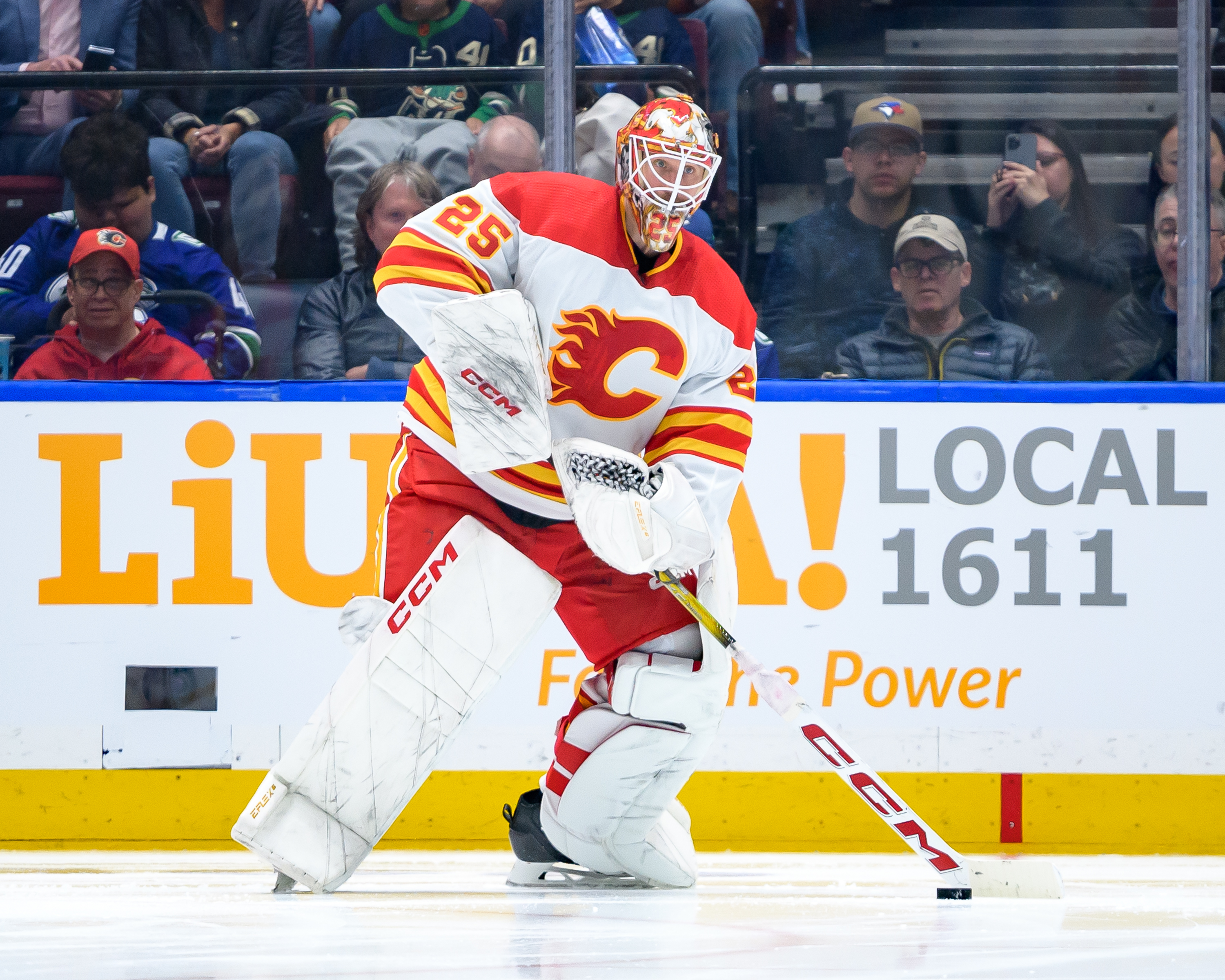 Jacob Markstrom of the Calgary Flames plays the puck during the second period of their NHL game against the Vancouver Canucks at Rogers Arena on April 16, 2024 in Vancouver, British Columbia, Canada.