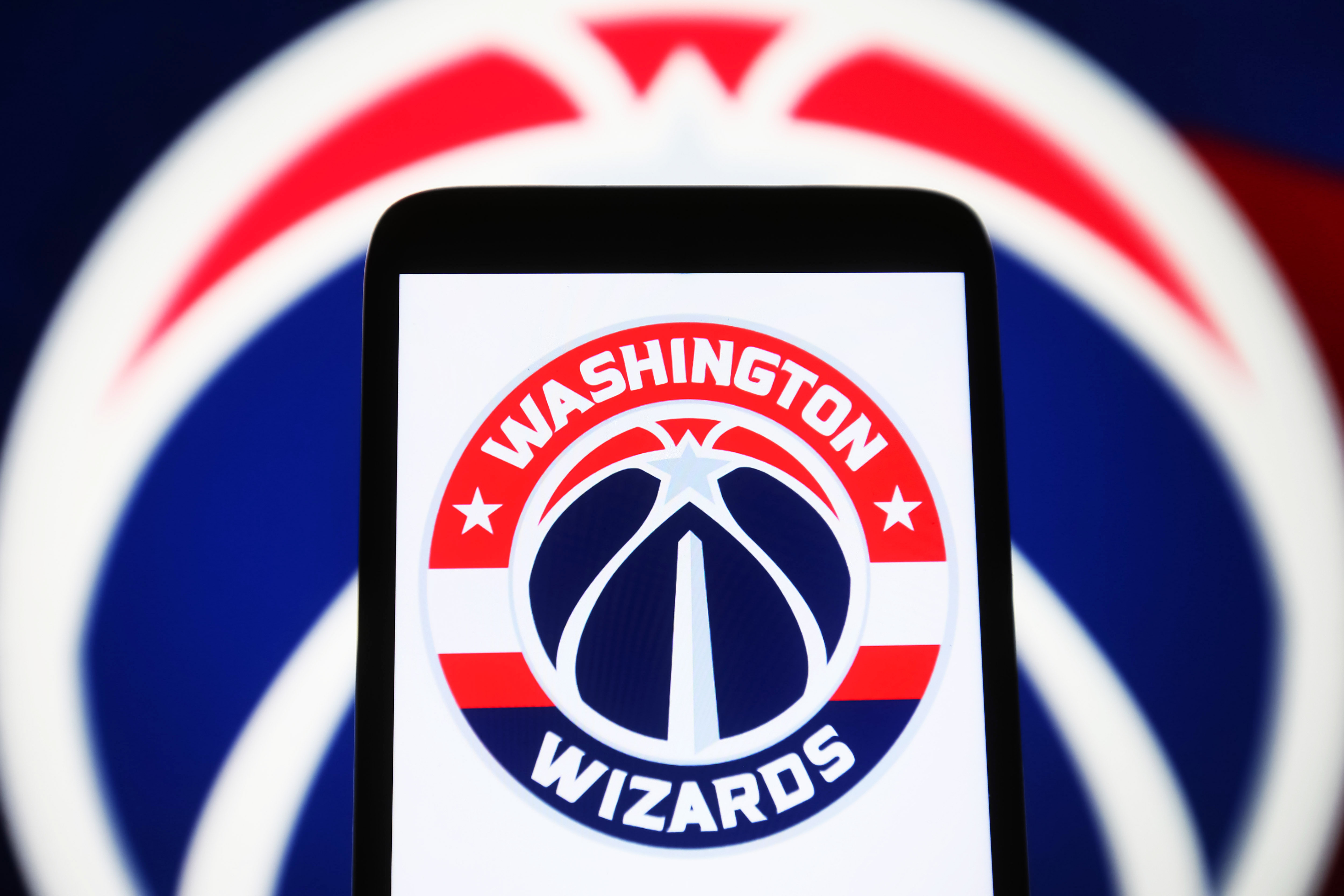 In this photo illustration, the Washington Wizards logo is...