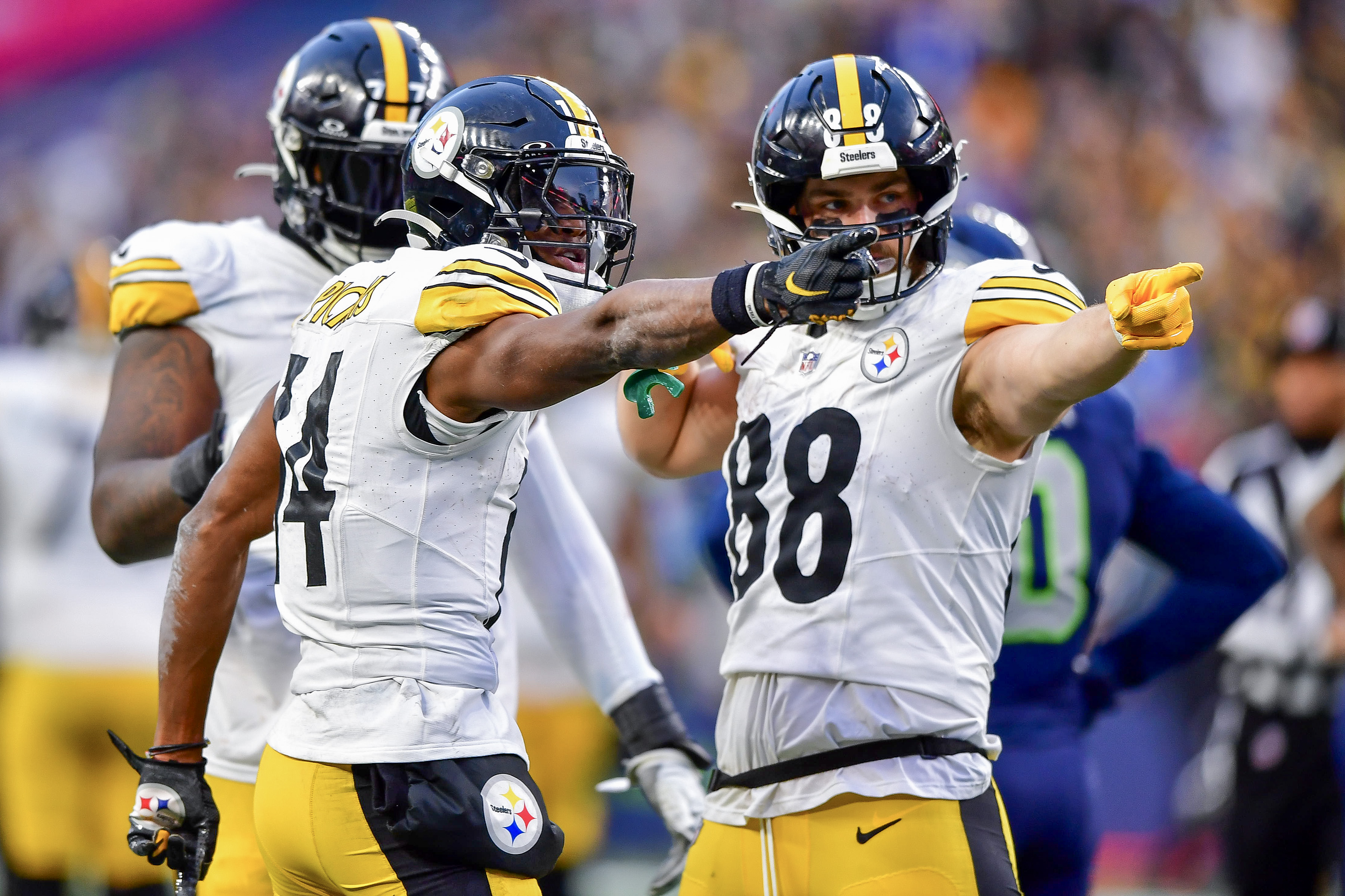 George Pickens #14 celebrates a first down with Pat Freiermuth #88 of the Pittsburgh Steelers during the fourth quarter of a game against the Seattle Seahawks at Lumen Field on December 31, 2023 in Seattle, Washington.