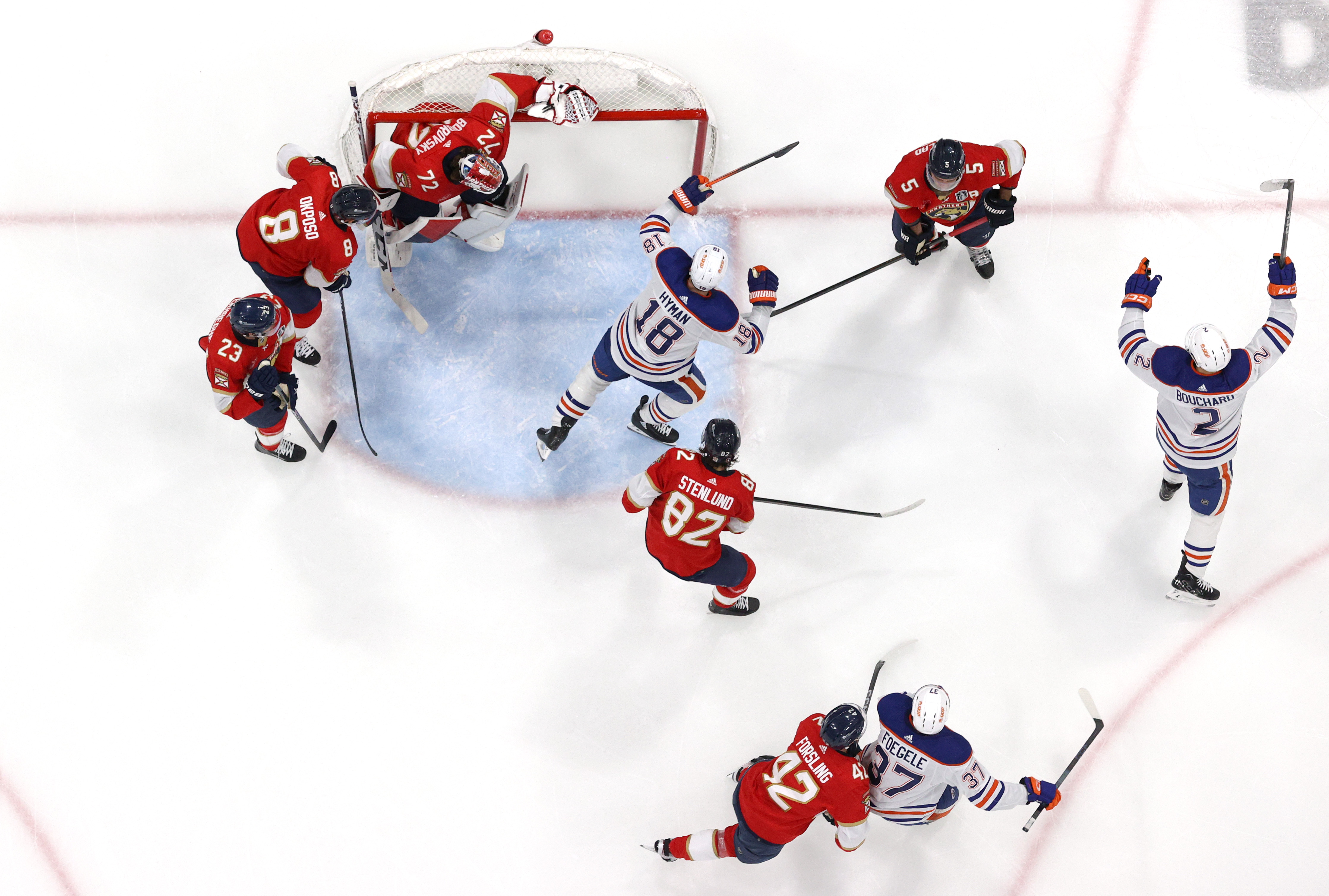 Evan Bouchard of the Edmonton Oilers reacts after a shot by teammate Connor McDavid goes into the net for a goal off the skate of goaltender Sergei Bobrovsky of the Florida Panthers during the third period of Game Five of the 2024 Stanley Cup Final between the Edmonton Oilers and the Florida Panthers at Amerant Bank Arena on June 18, 2024 in Sunrise, Florida.