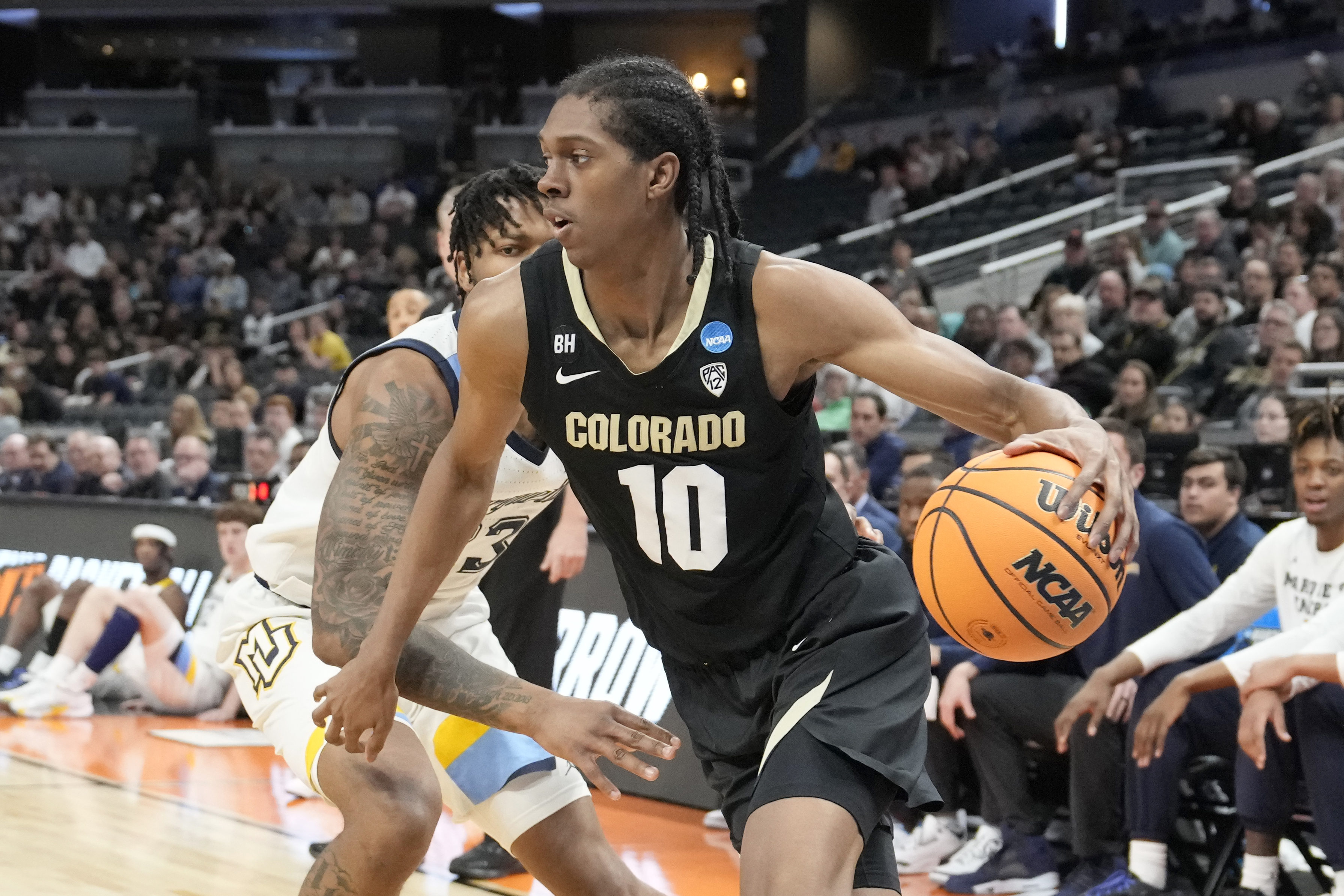 Cody Williams #10 of the Colorado Buffaloes dribbles the ball during the Second Round NCAA Men’s Basketball Tournament game against the Marquette Golden Eagles at Gainbridge Fieldhouse on March 24, 2024 in Indianapolis, Indiana.