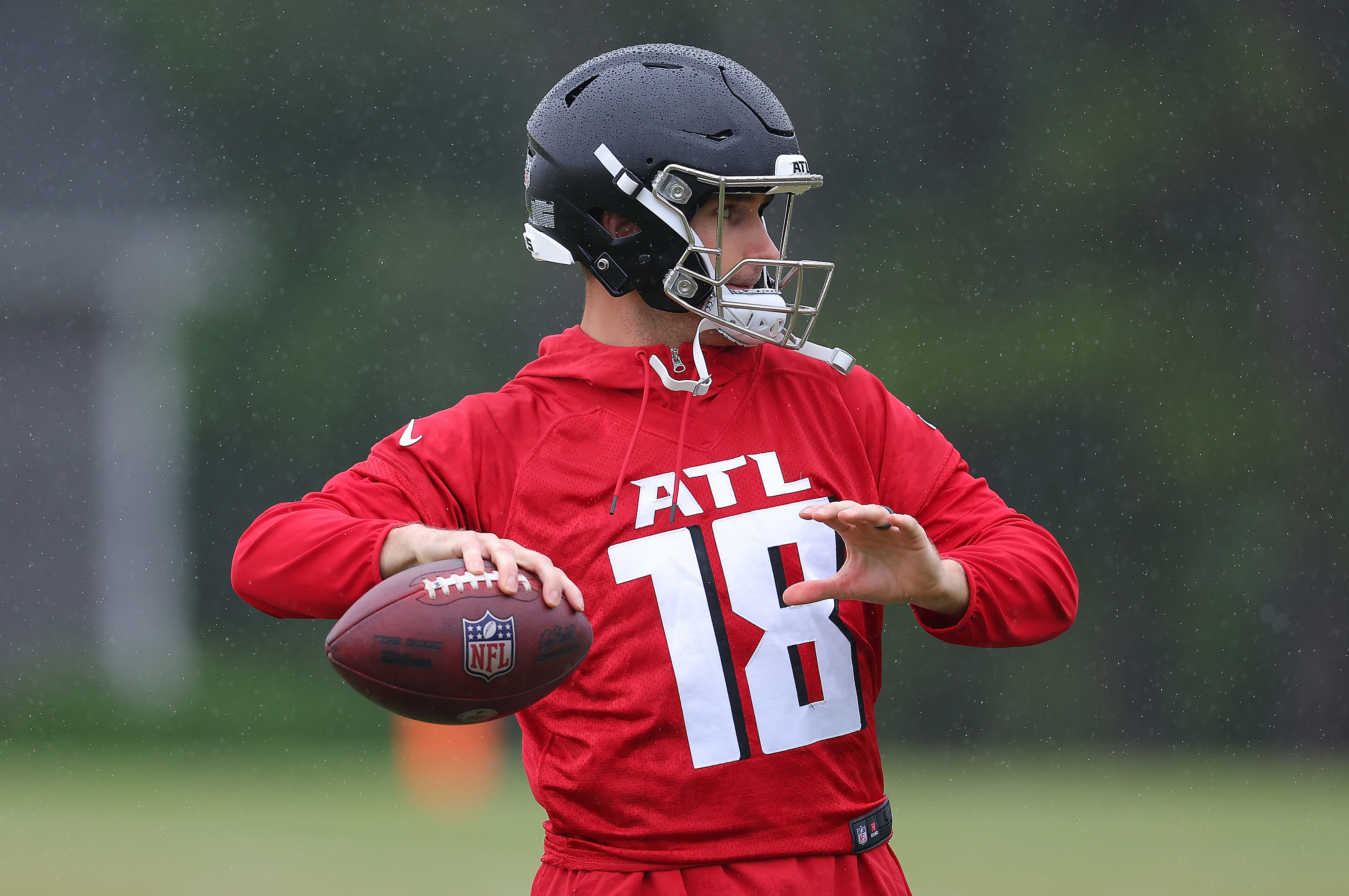 Quarterback Kirk Cousins #18 of the Atlanta Falcons runs drills during OTA offseason workouts at the Atlanta Falcons training facility on May 14, 2024 in Flowery Branch, Georgia.