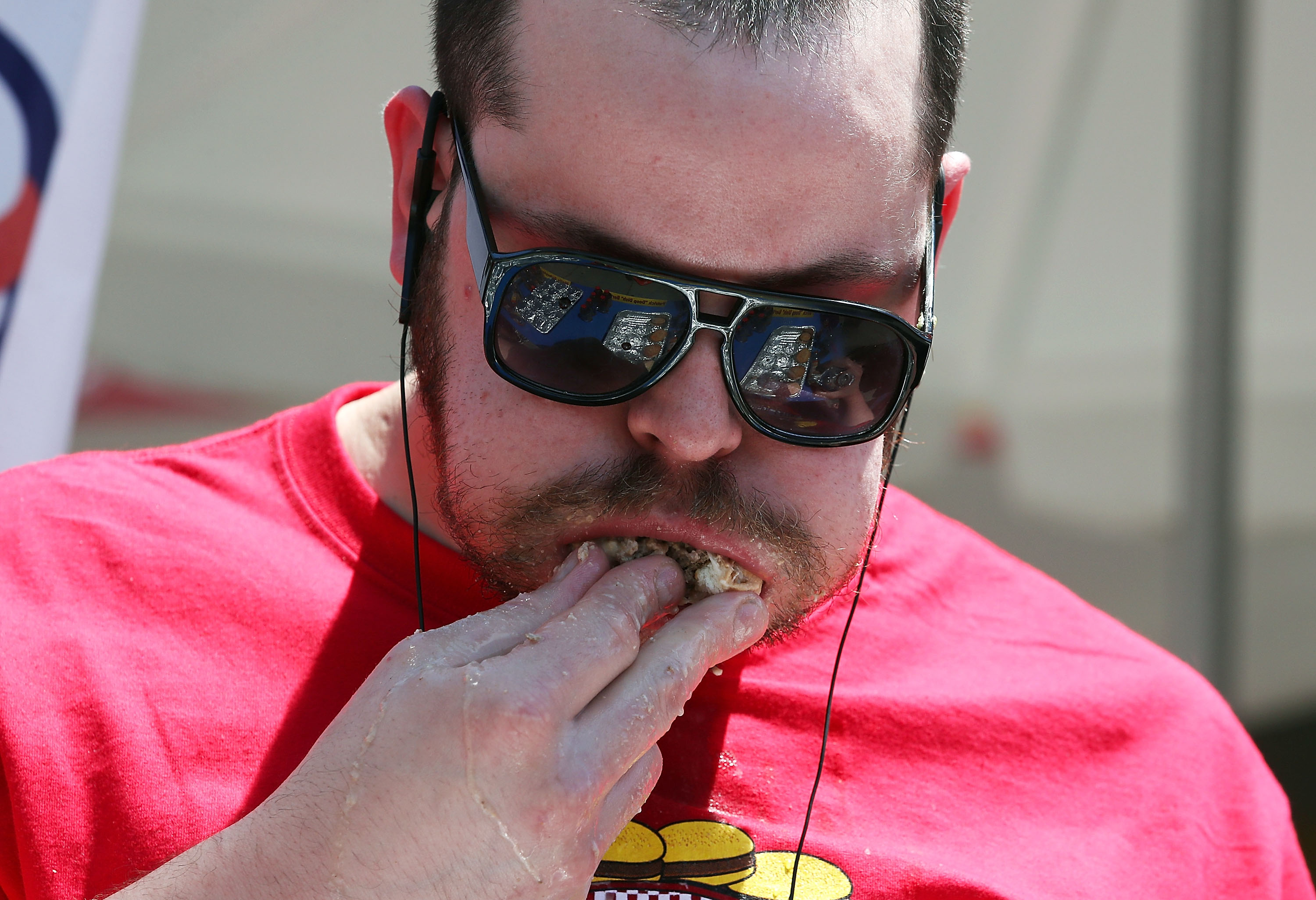 Patrick “Deep Dish” Bertoletti eats a hamburger during Z Burger’s eighth annual Independence Burger Eating Championship, on July 3, 2017 in Washington, DC. Molly Schuyler won the competition by eating 21 hamburgers.