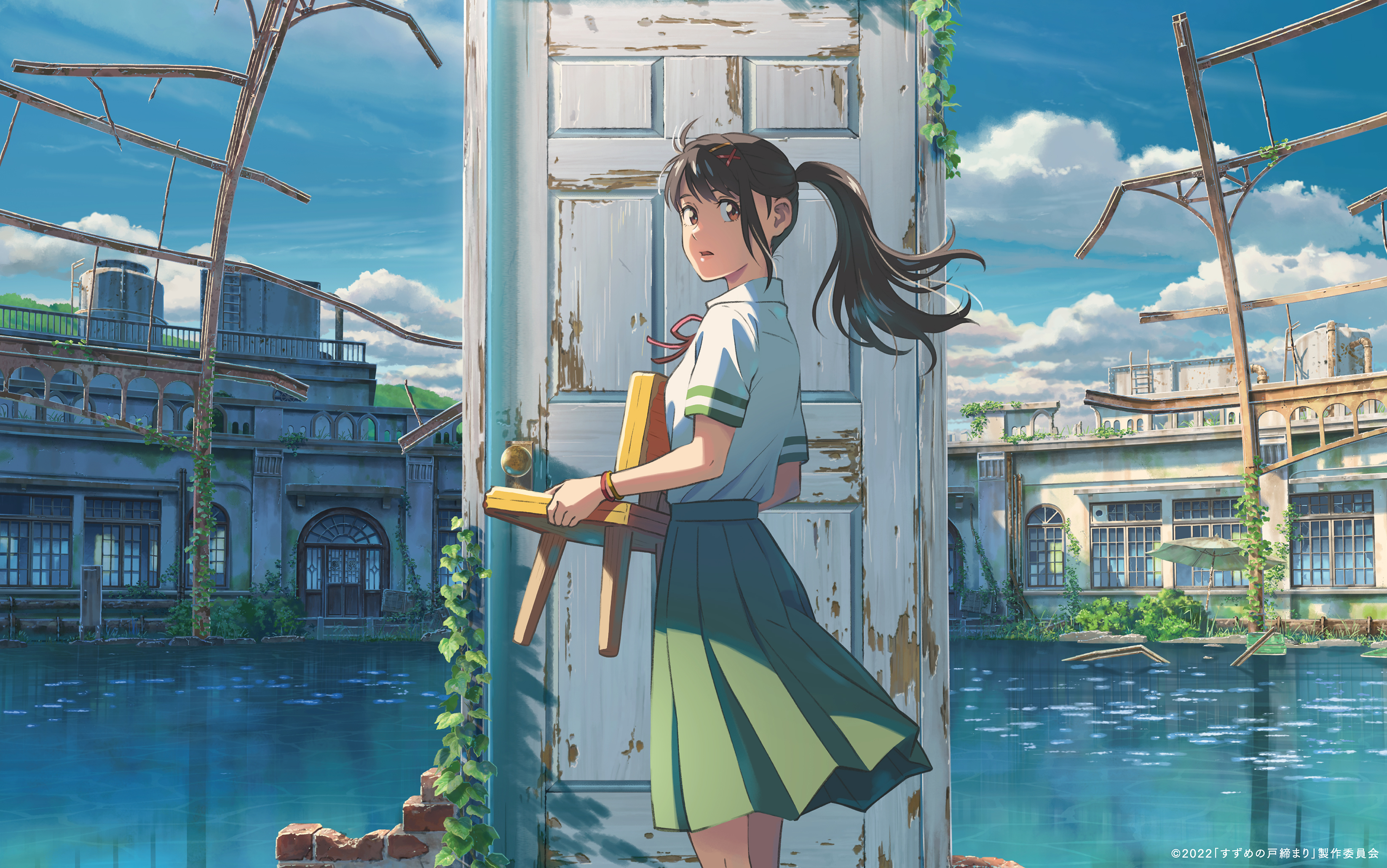 Suzume, a teenage girl in a school uniform, holds a chair as she stands in front of a dilapidated doorway in the middle of a shallow body of water, which itself is in the middle of some ruins
