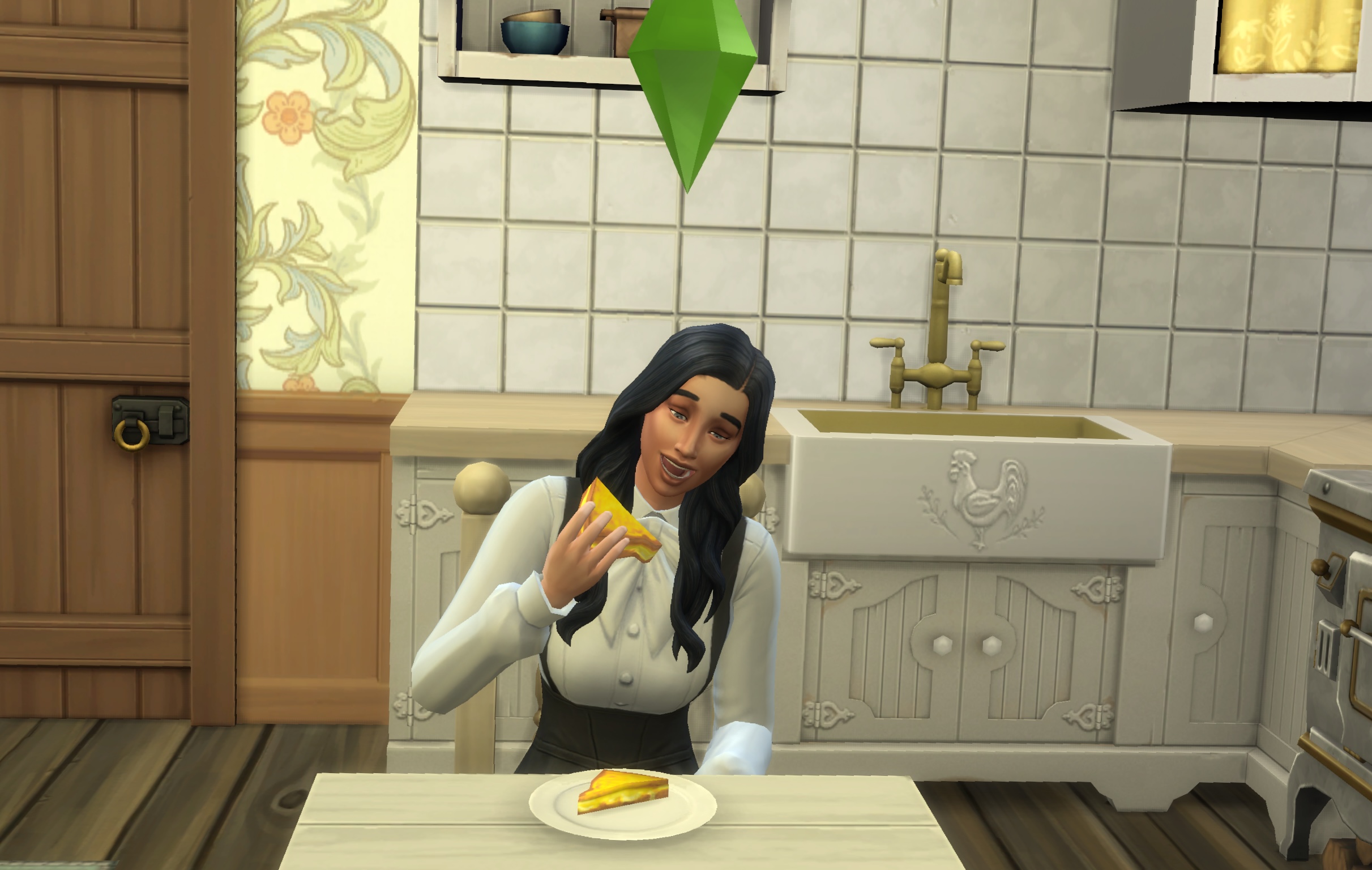 The Sim, Gabriella Duke, sitting at a table in her kitchen eating a grilled cheese sandwich.