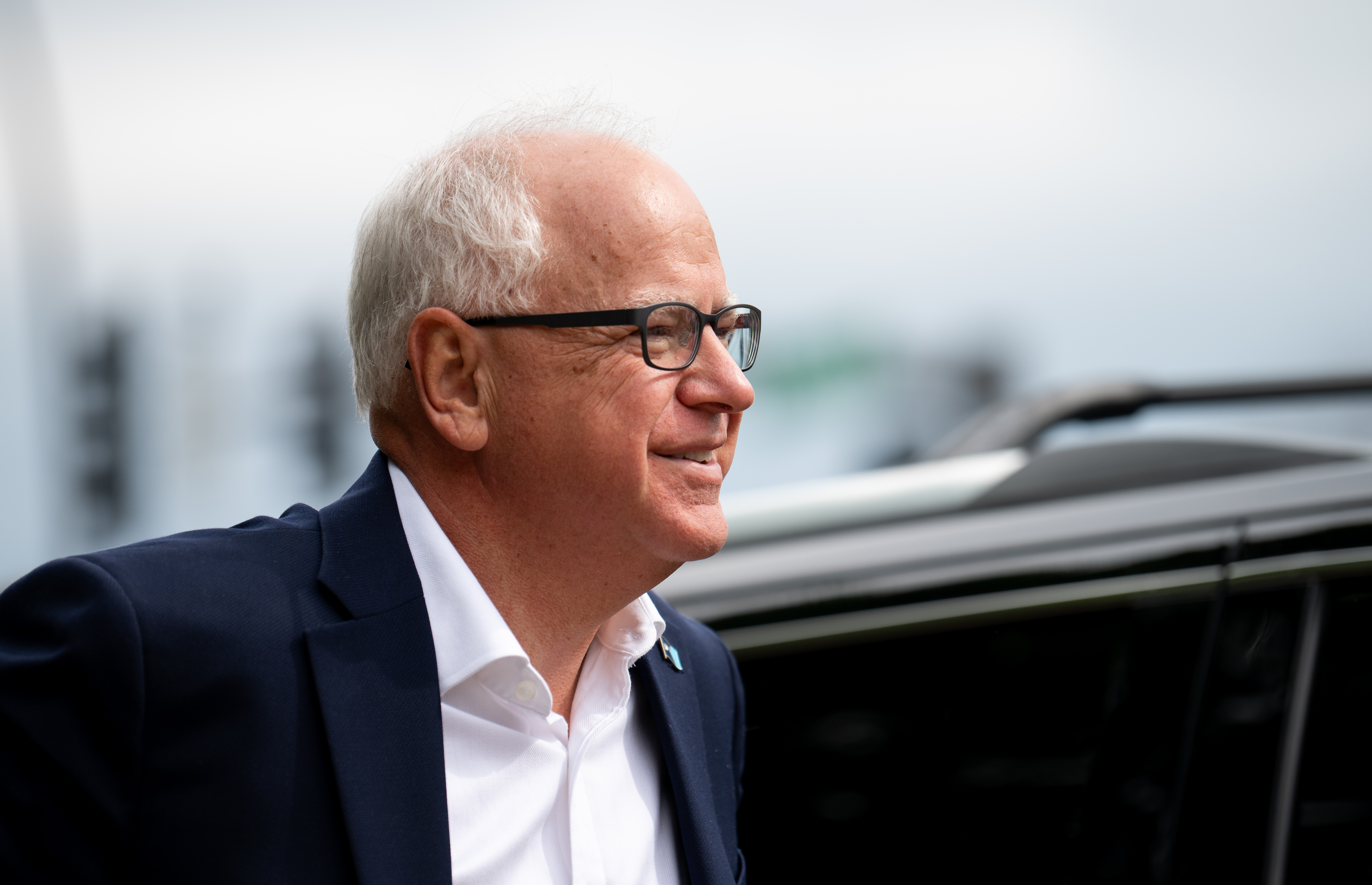 A white man wearing glasses photographed in profile